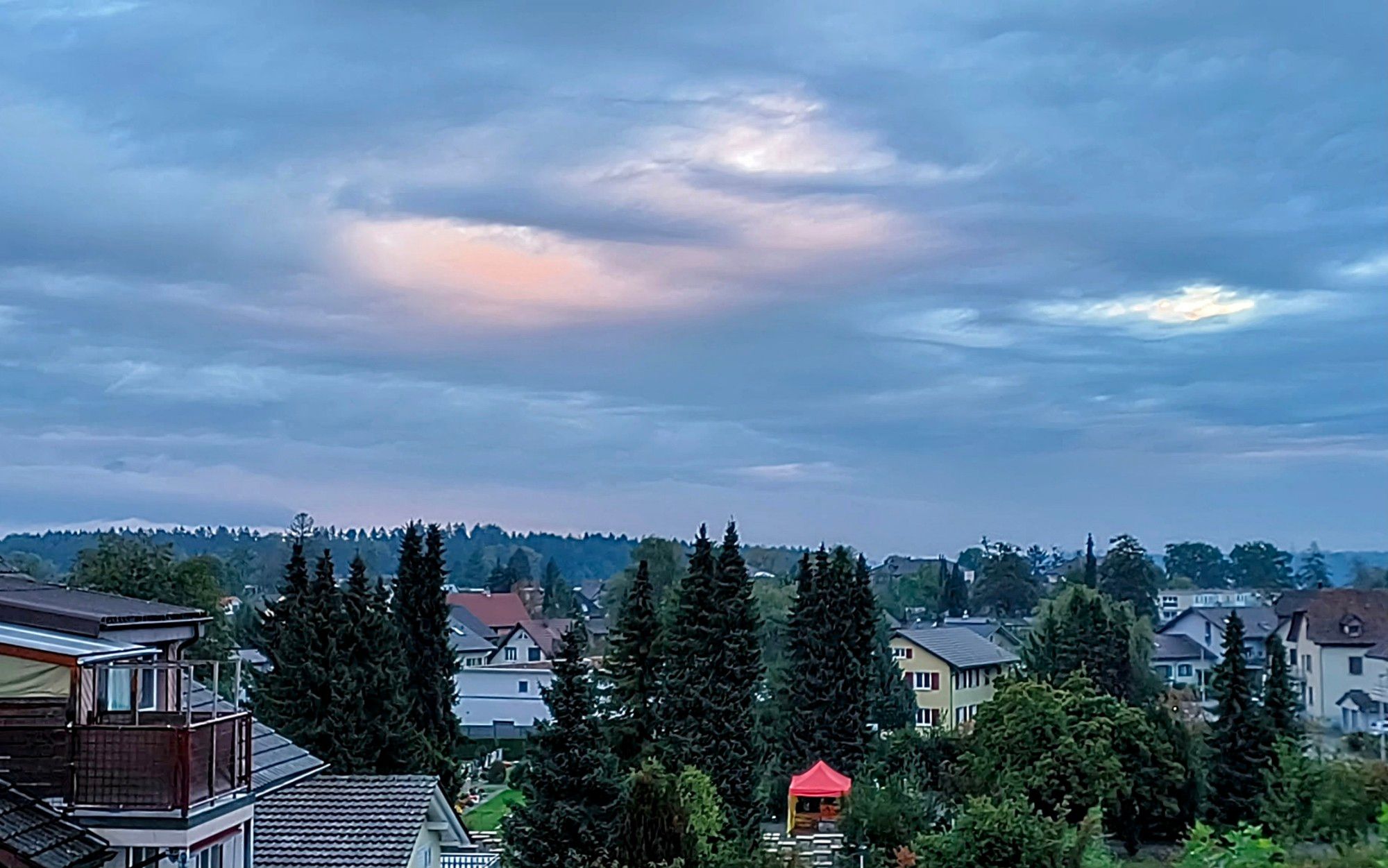 Sonne in den Wolken über Dorf.