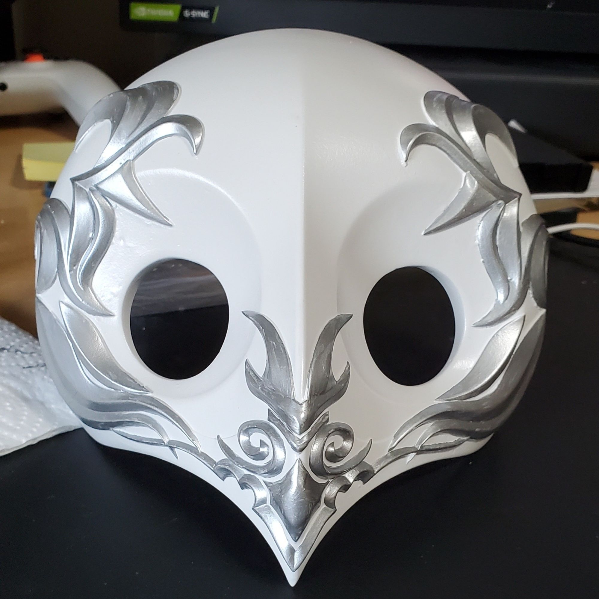 A white mask with silver filigree, for a Hythlodaeus cosplay from FFXIV