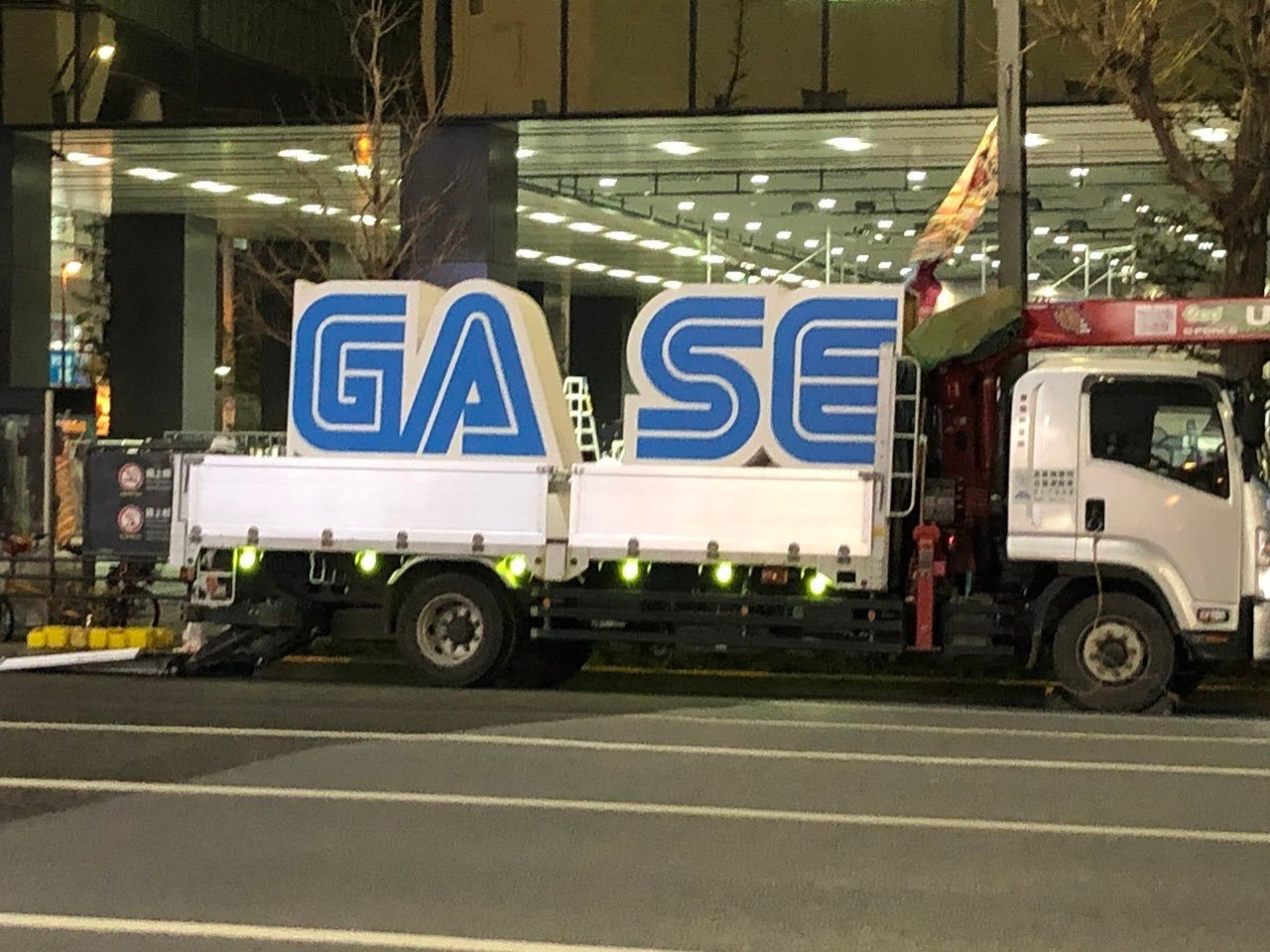 A truck carrying a two piece Sega sign, but it's in the wrong order so it says "Ga" "Se"