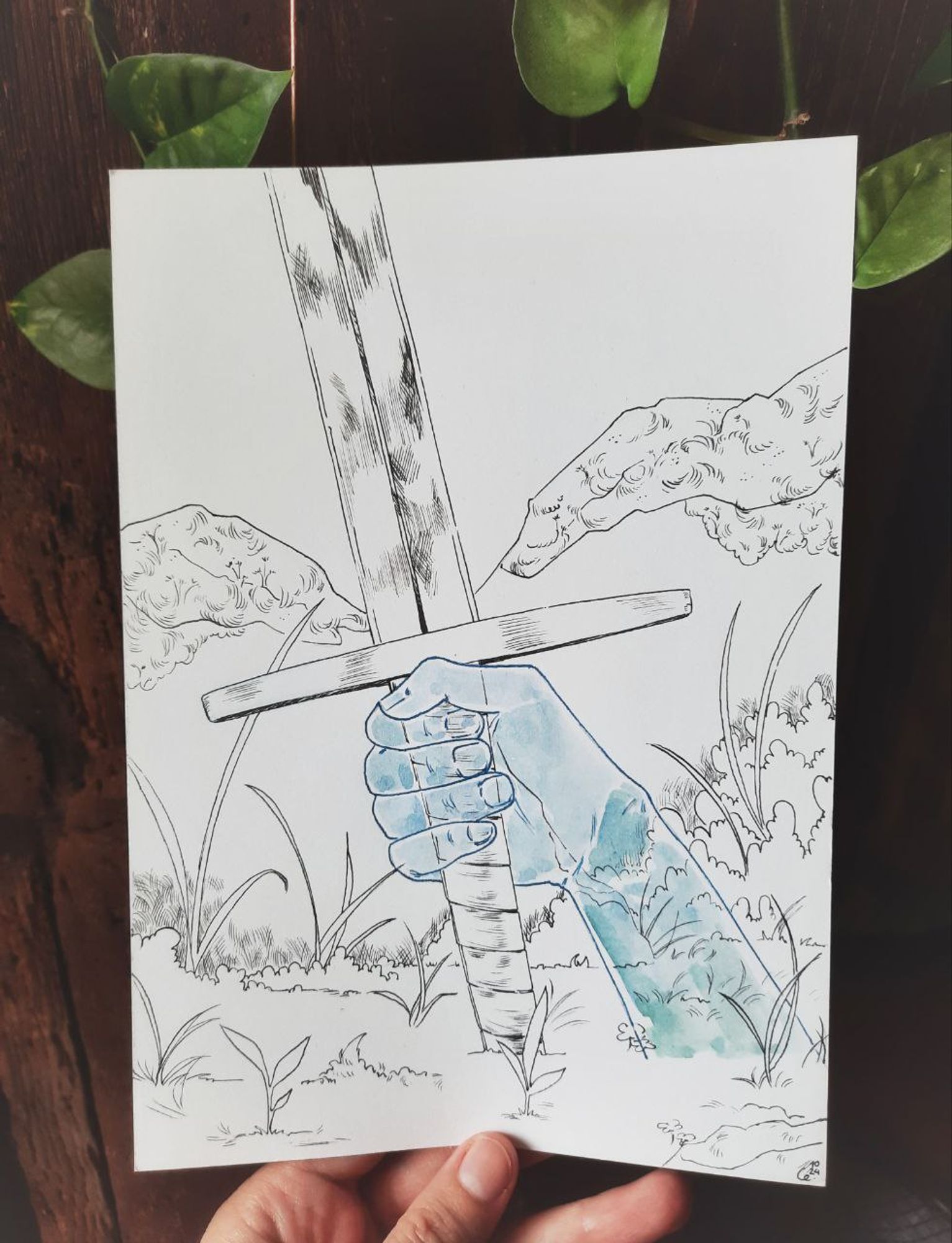 Photo of a drawing in ink and watercolour of a spectral hand coming out of the ground and holding a longsword, the hilt, guard, and part of the blade visible. The hand and sword are surrounded by vegetation and rocks. The hand is blue and transparent and everything else is in black and white.