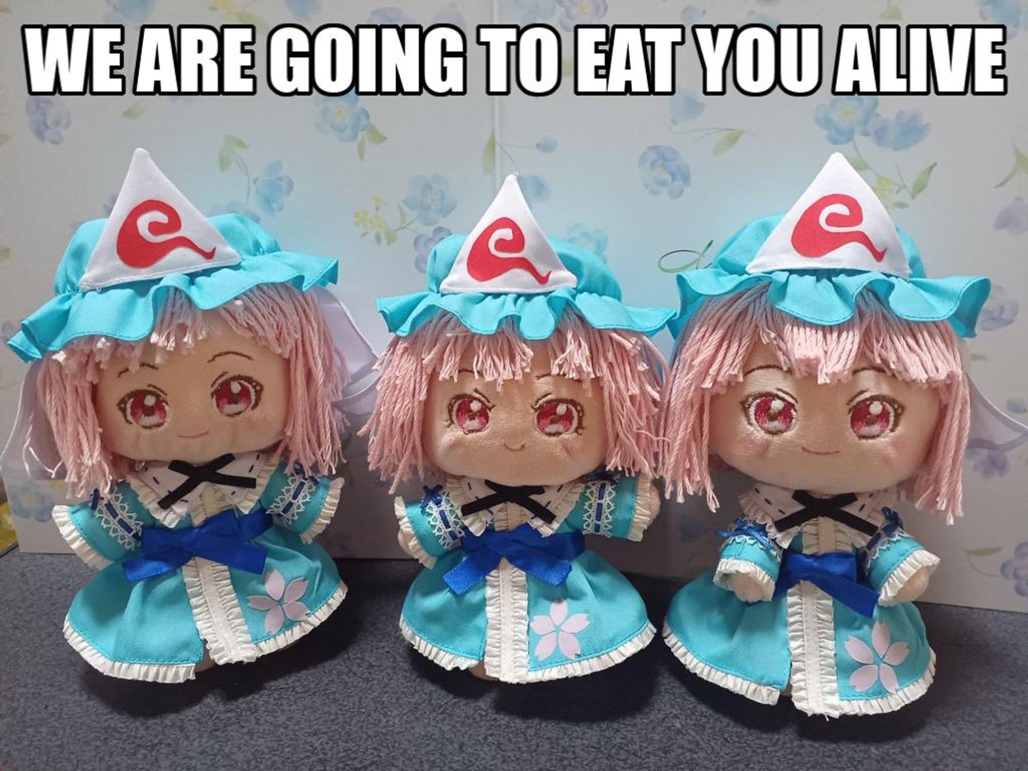 An image of three Yuyuko plush toys with the caption "We are going to eat you alive"