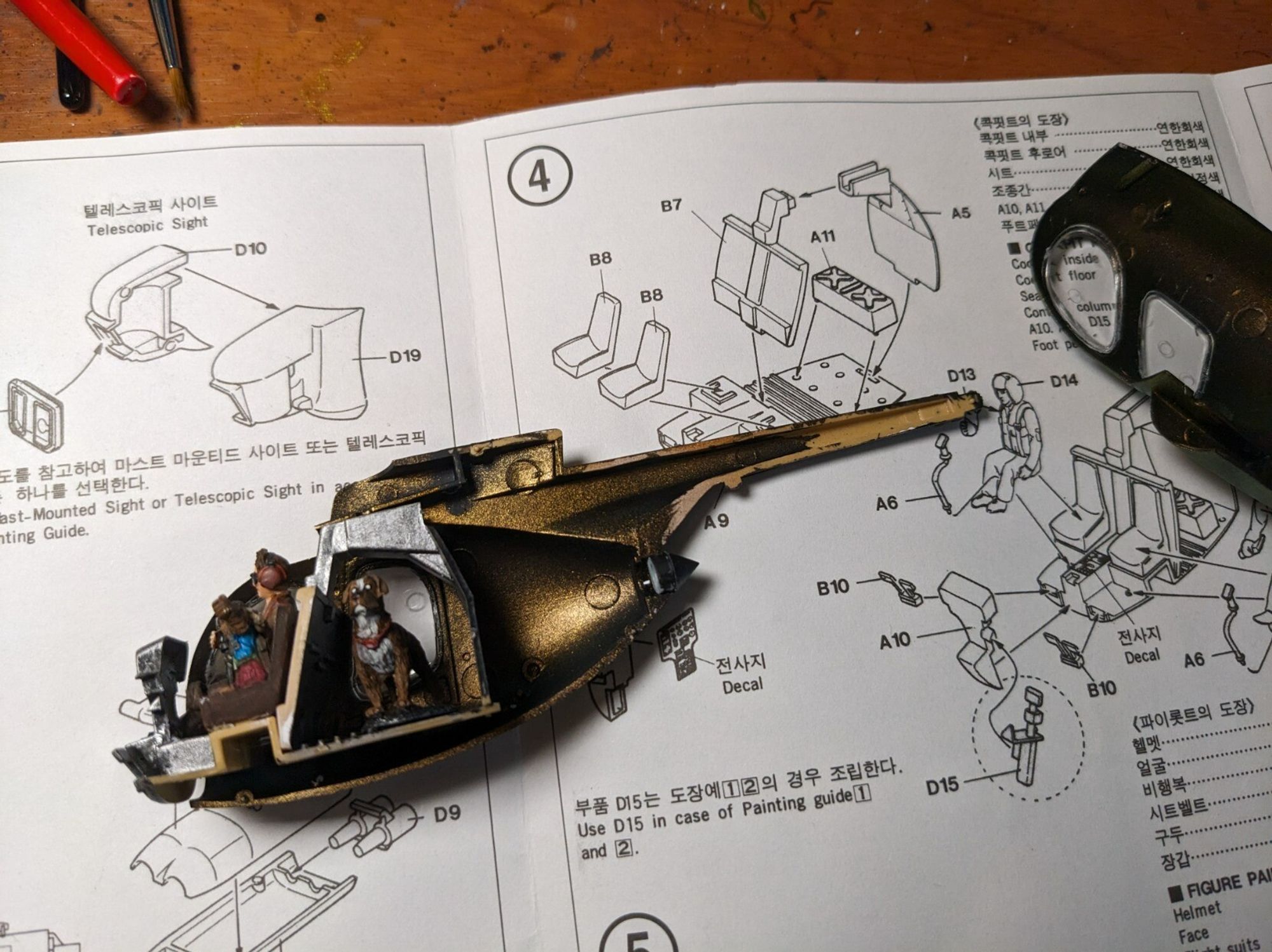 A model of a helicopter being built, behind the model are the instructions, in English and Korean. Picture courtesy of crafter iris_of_ether.