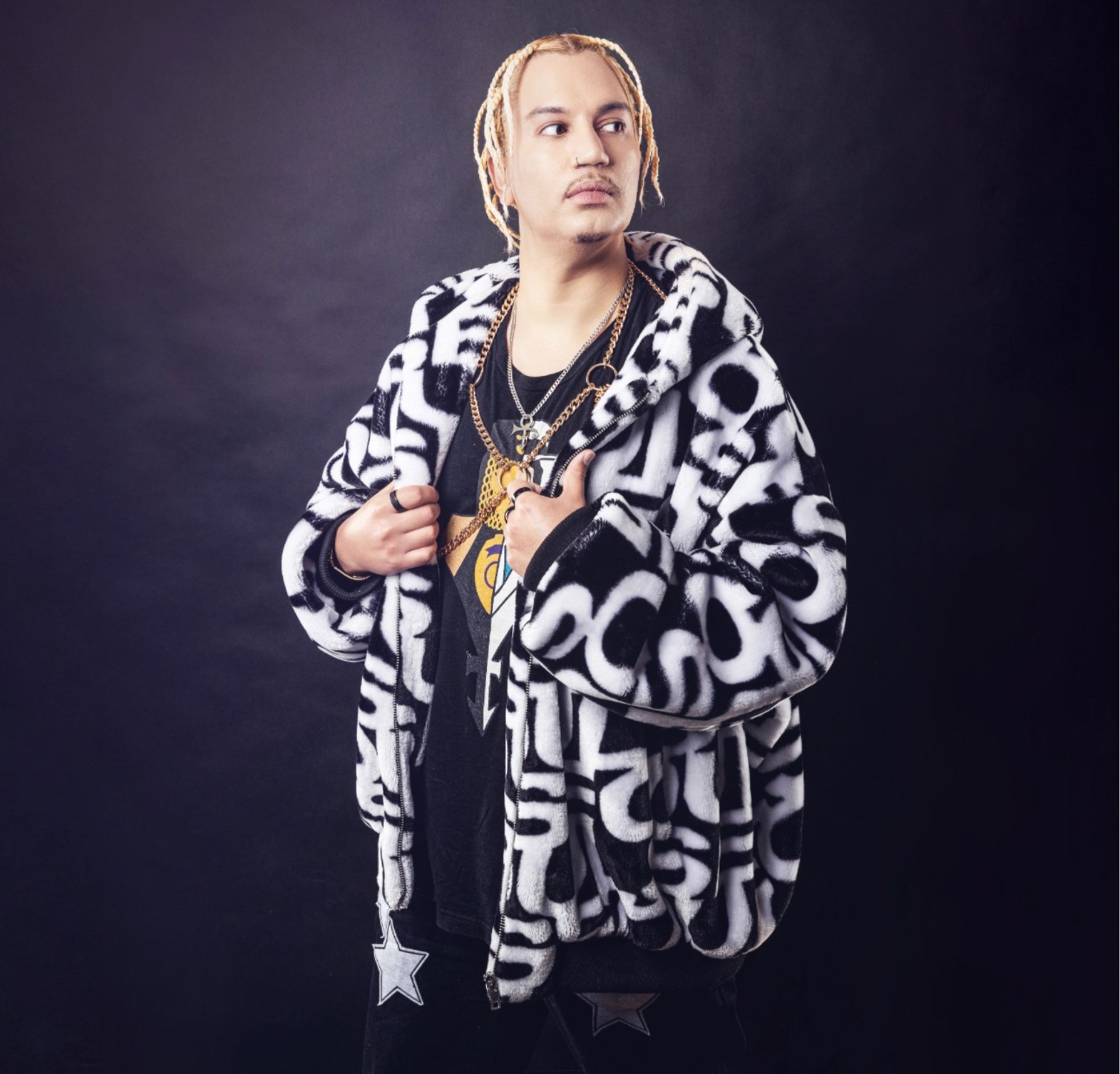 a professional shoot of me, casey rain. i have blond braided hair and i am wearing a big fuzzy jacket 