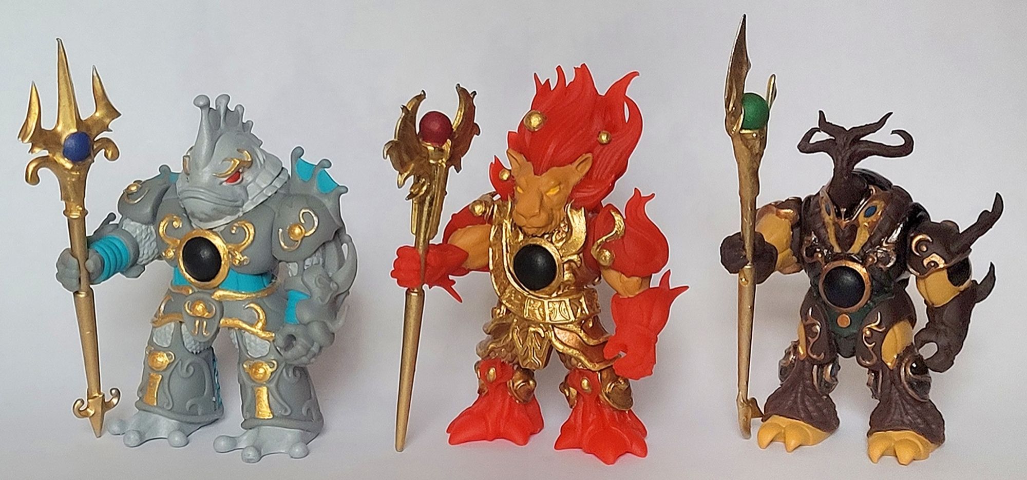 Photograph of 3D printed figures based on the artwork of the unreleased "Three Wise Ones" characters - WaterTuna, FireLion, and WoodBeetle. Sculpted by Neromorus and painted by me.