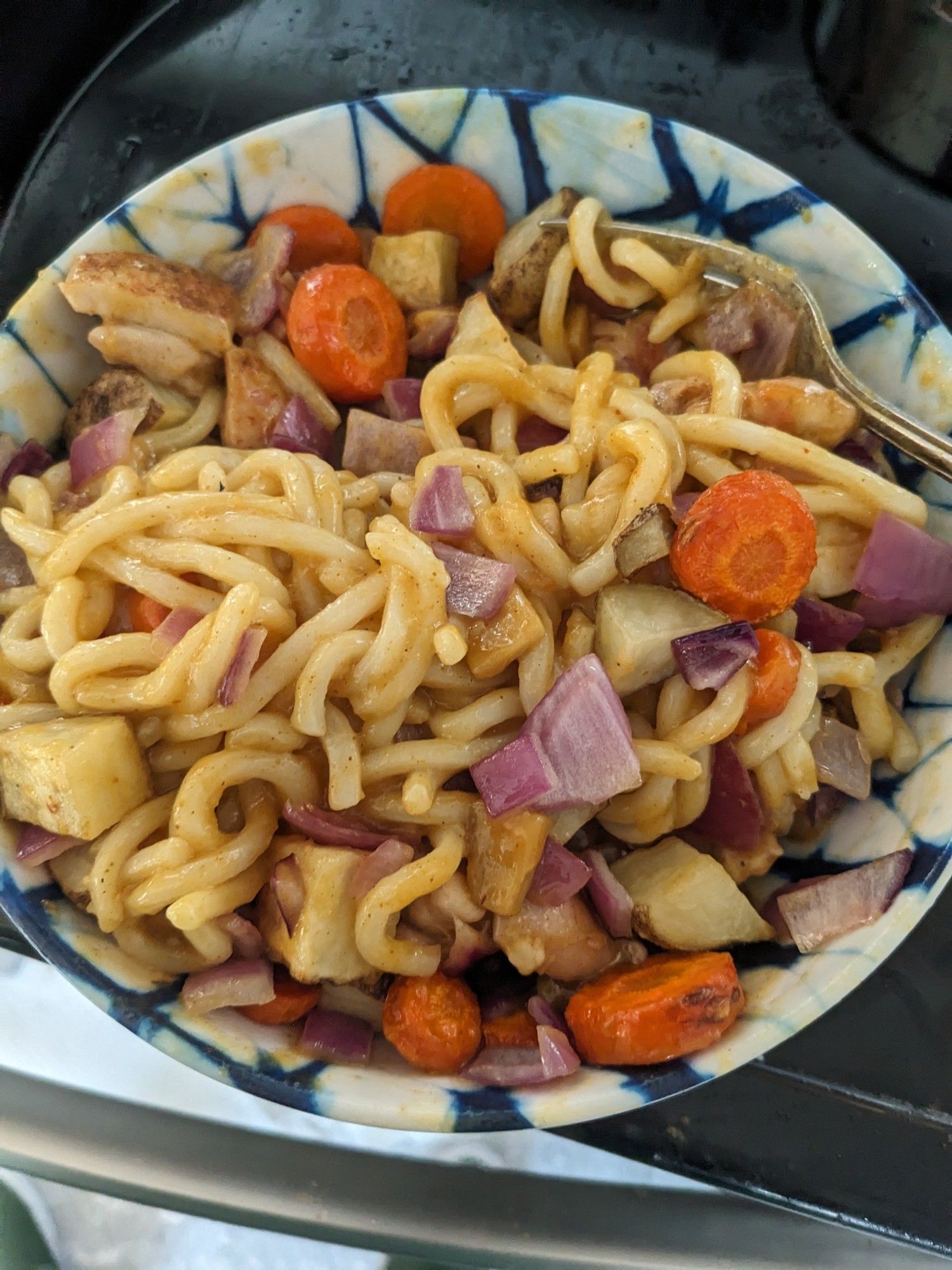 A bowl of chicken curry udon using the ingredients from the previous picture, but the vegetables have been chopped and roasted and the chicken cubed and cooked.