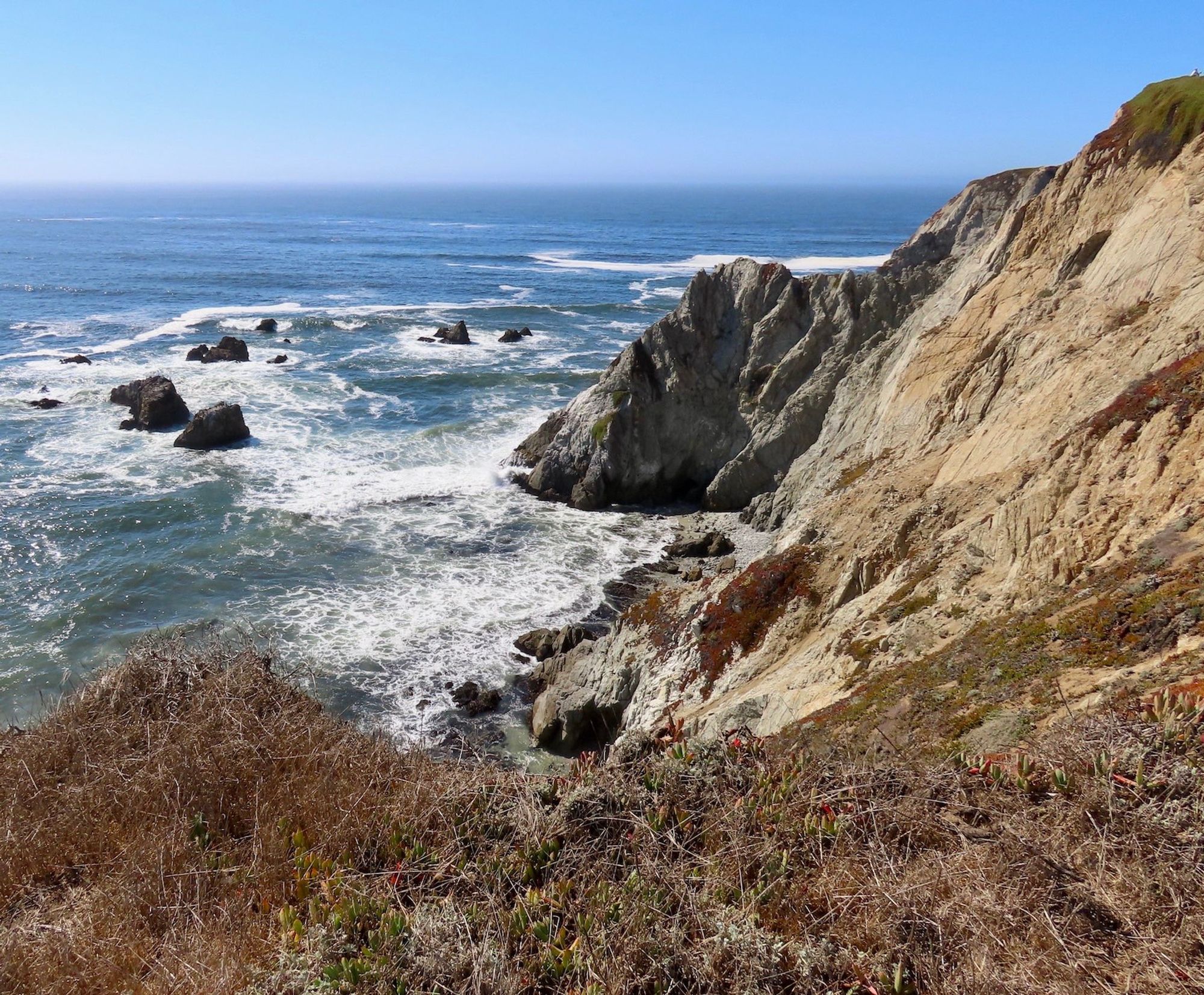 Another long view with cliffs on the right side and ocean to the left.