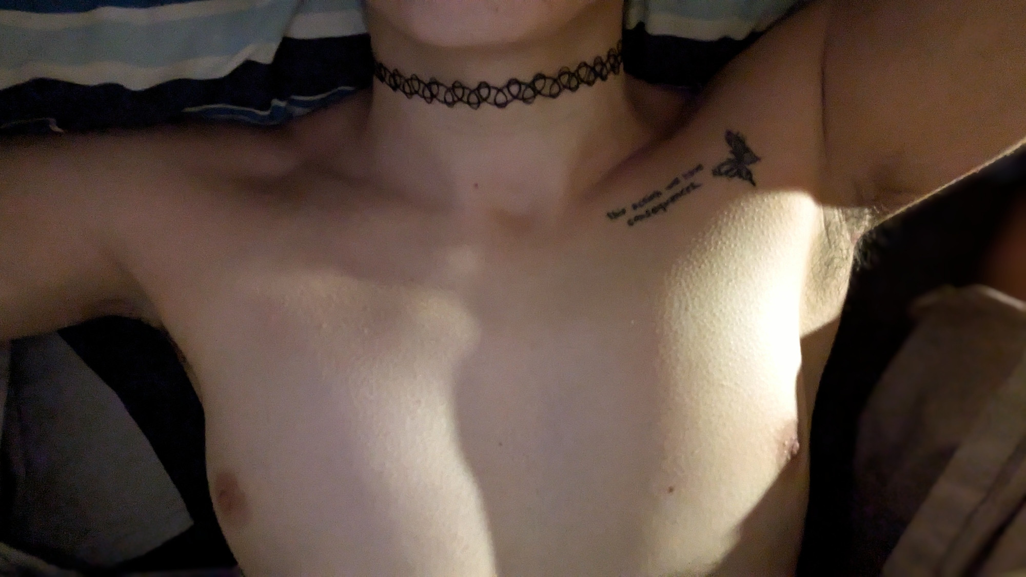 A photo of Sable's upper torso. Her arms open, her tits exposed, her neck presented as an offering. She's wearing a small tattoo necklace (choker).