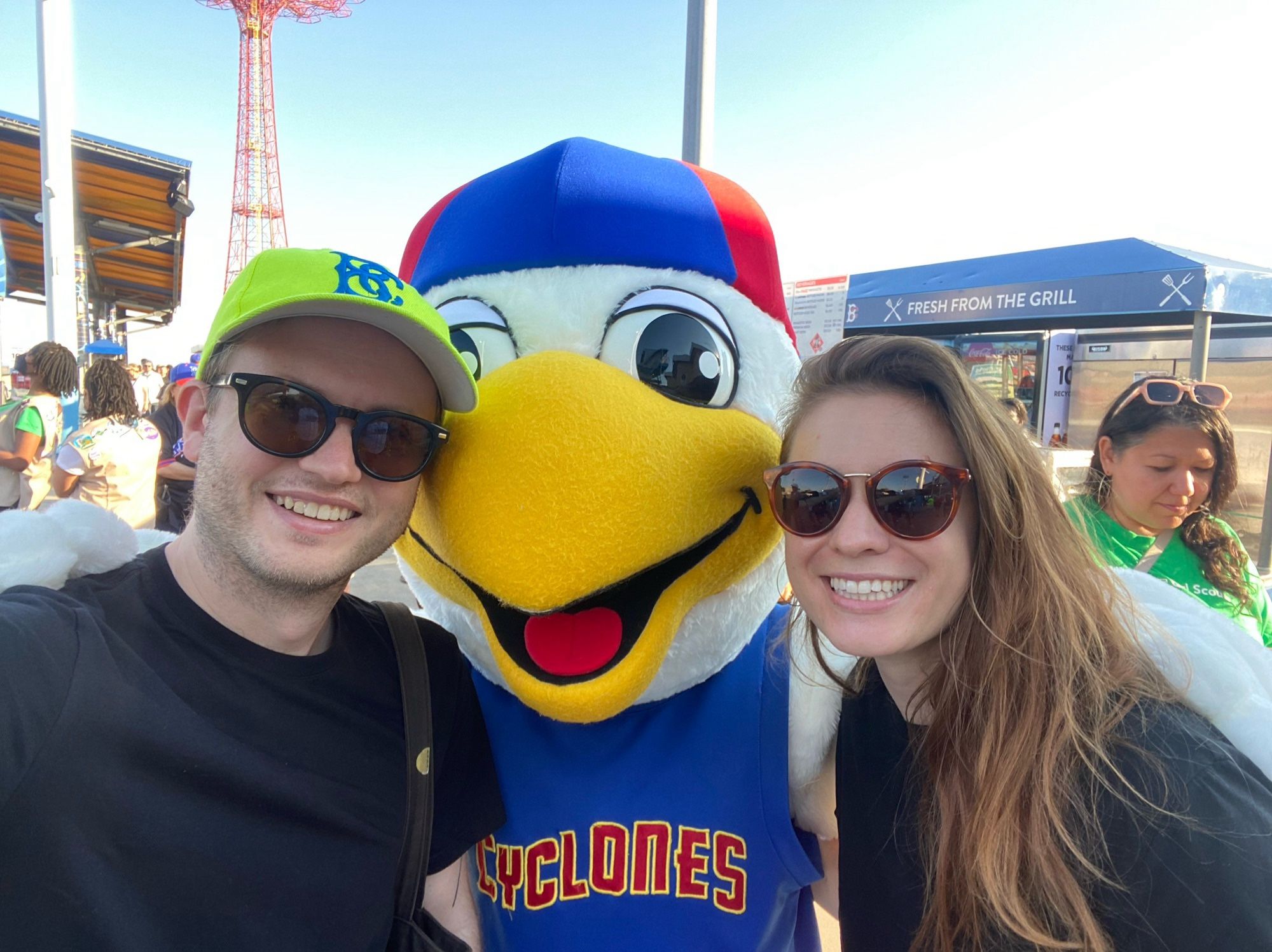 Parker and Brooke with a seagull mascot at a Cyclones game