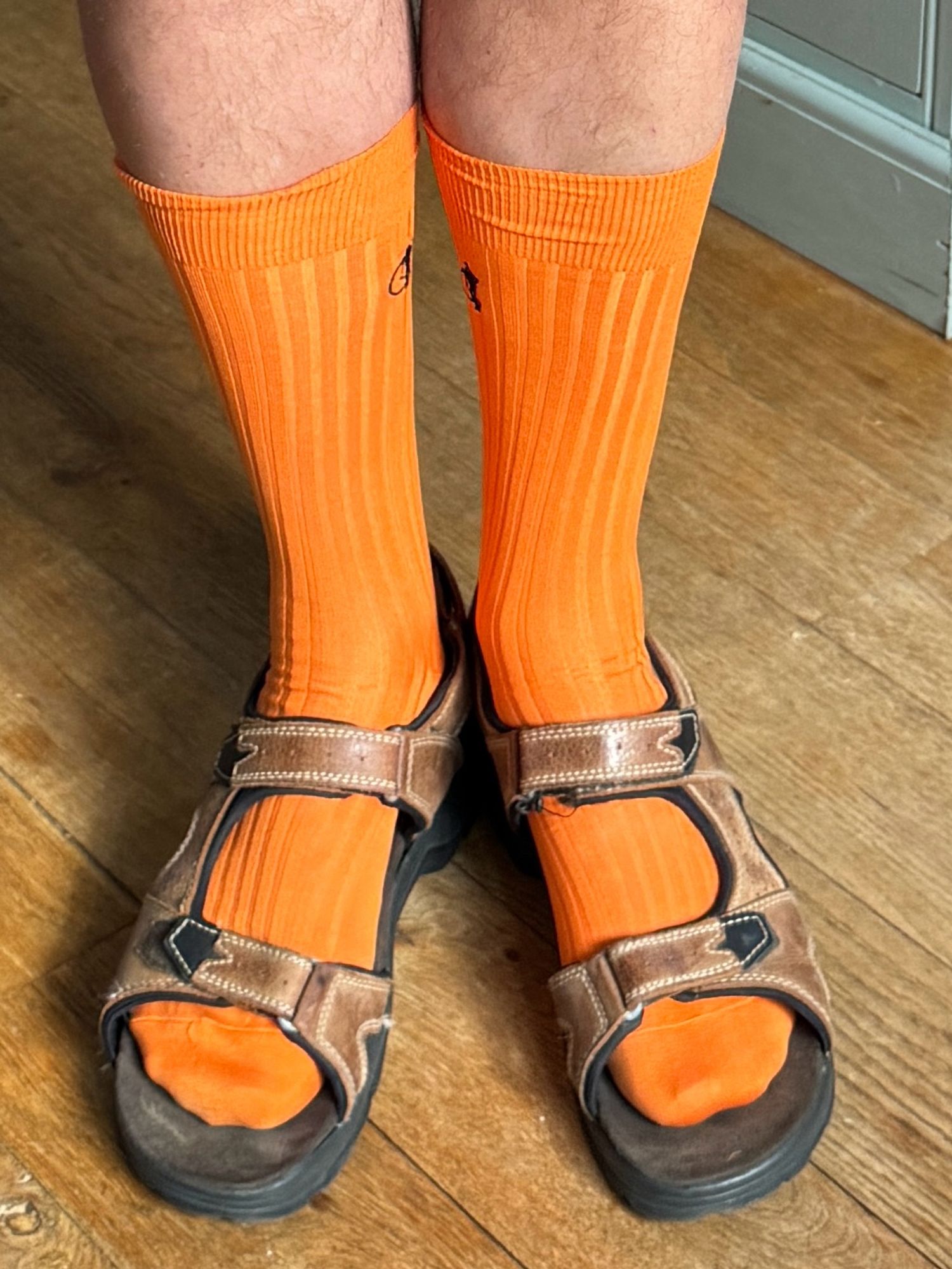 “selfies”
of bright orange socks pulled up with brown sandals