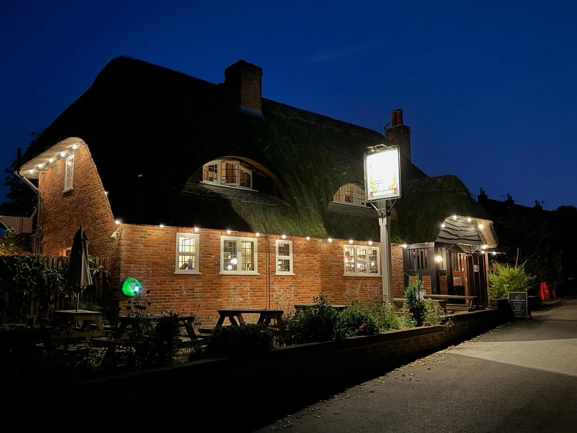 Picture of The Tichbourne Arms pub in Hamphire taken in the evening