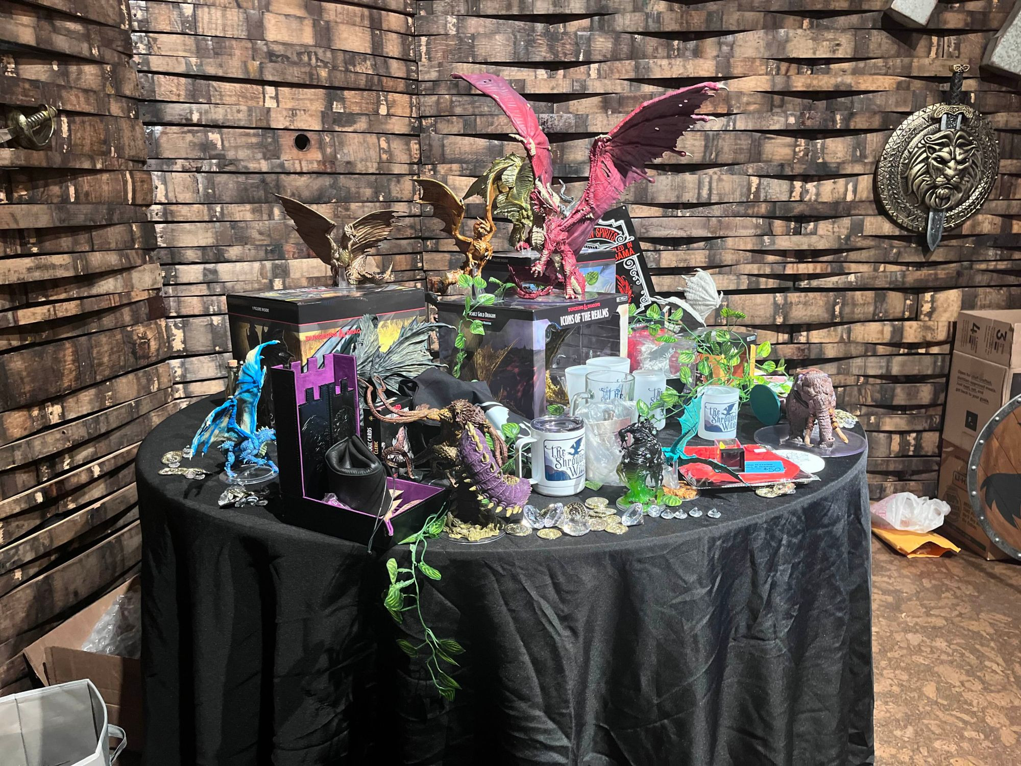 A table full of DnD prizes with numerous dragons.