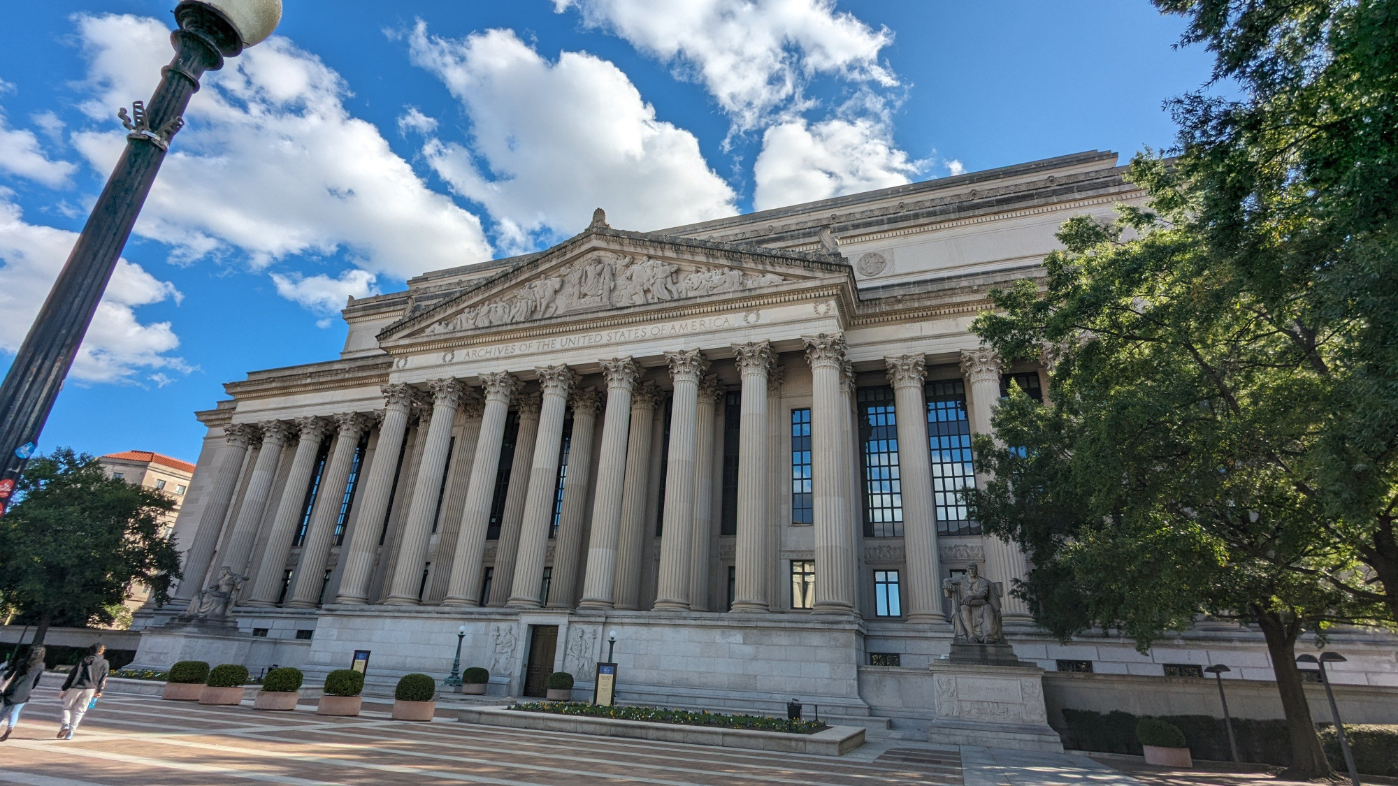 A picture of the national archives set against a blue sky with fluffy clouds.