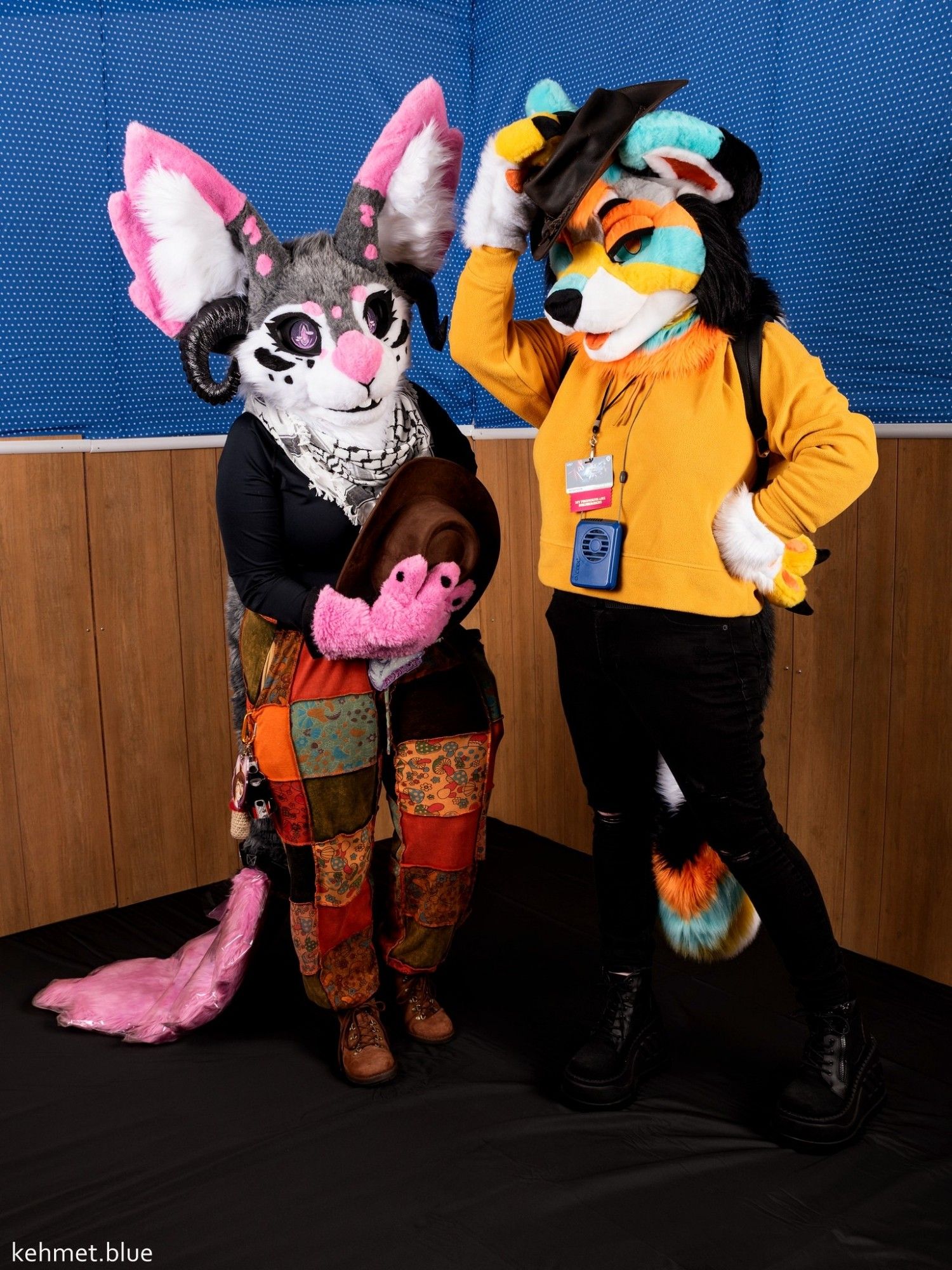 Bunny fursuiters bowing with cowboy hat with colourful dog suiter tips cowboy hat