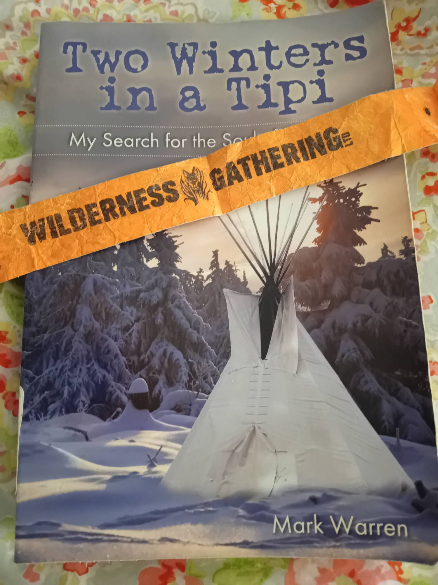 A book - two winters in a tipi, and a wristband from the wilderness gathering.