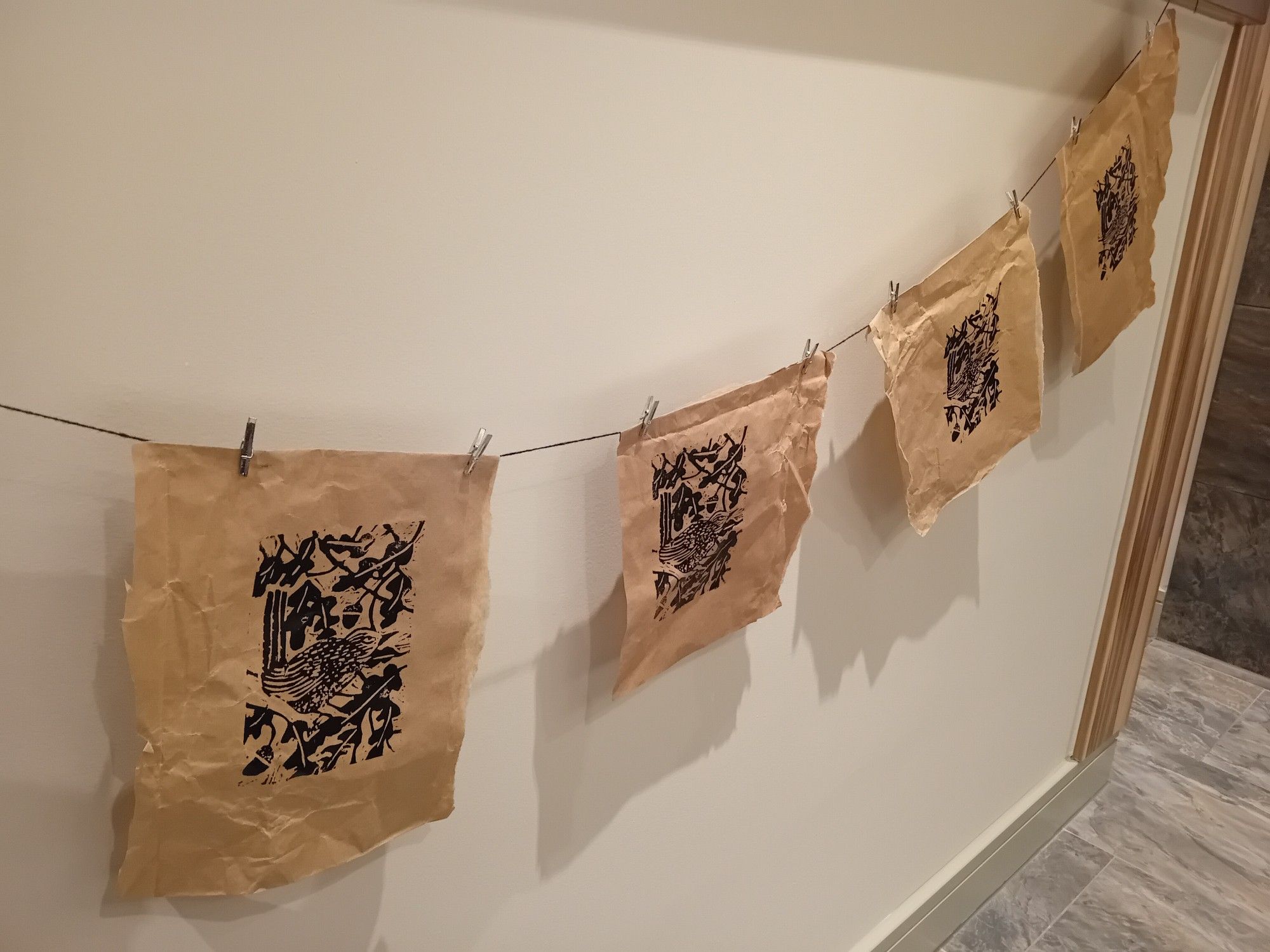 A few lino prints pegged to a string.