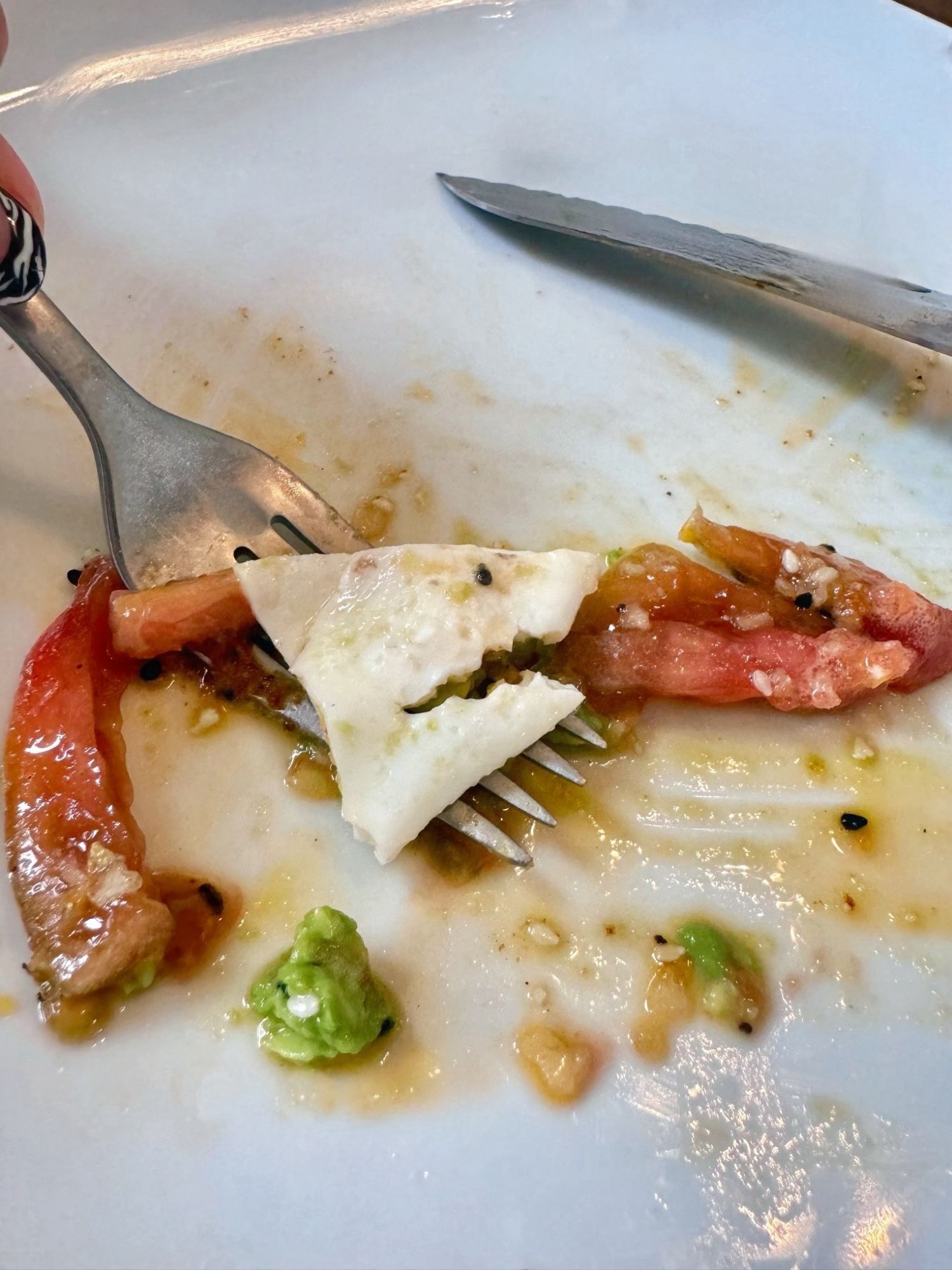 A final piece of egg, shaped like the head of a great white shark with a black sesame seed eye, sat on my fork amid the remnants of tomatoes and avocados from my toast.