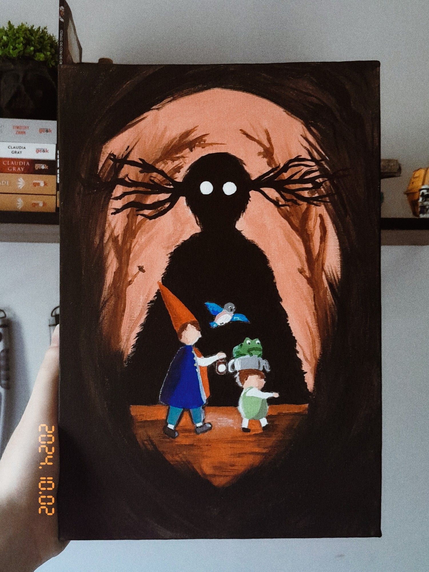 Uma pintura em tela 20x30cm do desenho over the garden wall
Em uma floresta escura, Wirt, Greg caminham para a direita. Wirt segura um lampião enquanto Greg marcha em sua frente com Jason Funderburke na cabeça e Beatrice sobrevoando.
Ao fundo a silhueta da Besta os observa se forma sombria.
A paleta de cores segue no preto, marrom, laranja e as cores típicas dos personagens.