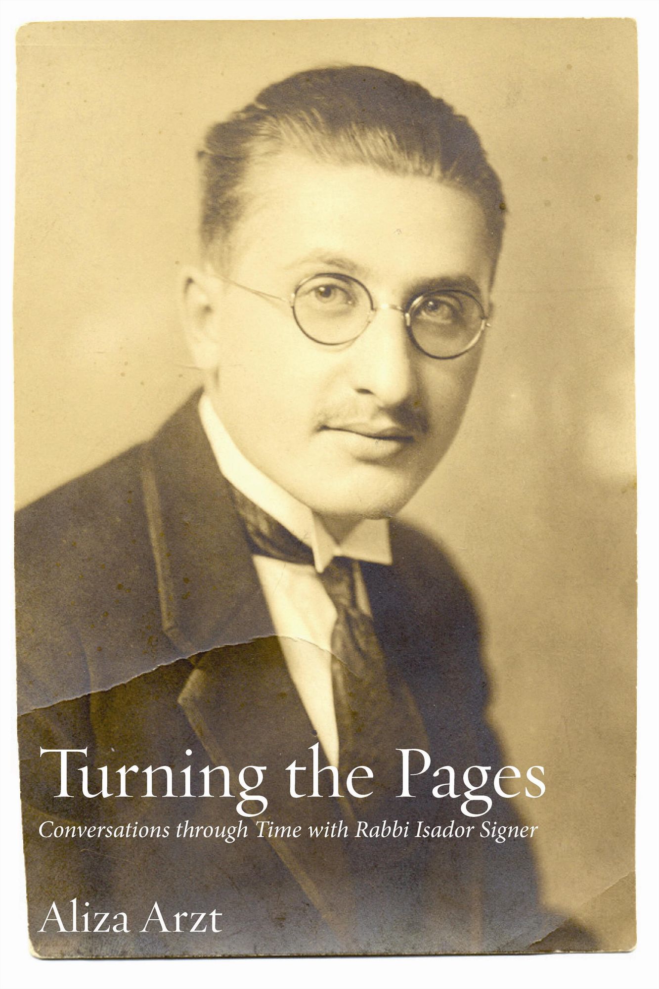 cover of TURNING THE PAGES; cover is a black and white head and shoulder gold tinted photo of Singer with short slicked back hair, round glasses, a slight mutached, jacket and tie.