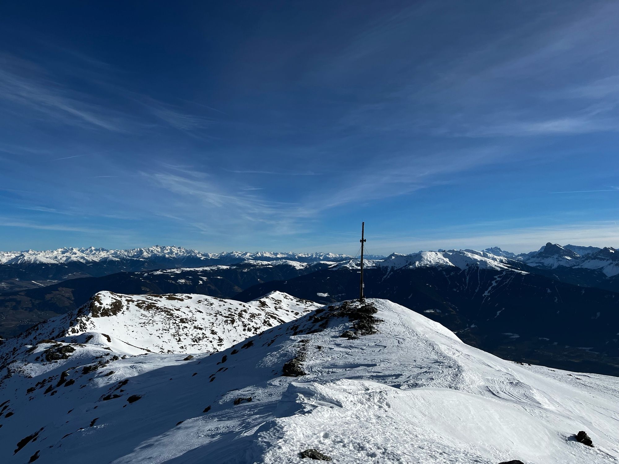 The snow covered peak from another angle. Amazing view of the Alps and Dolomites in the background.