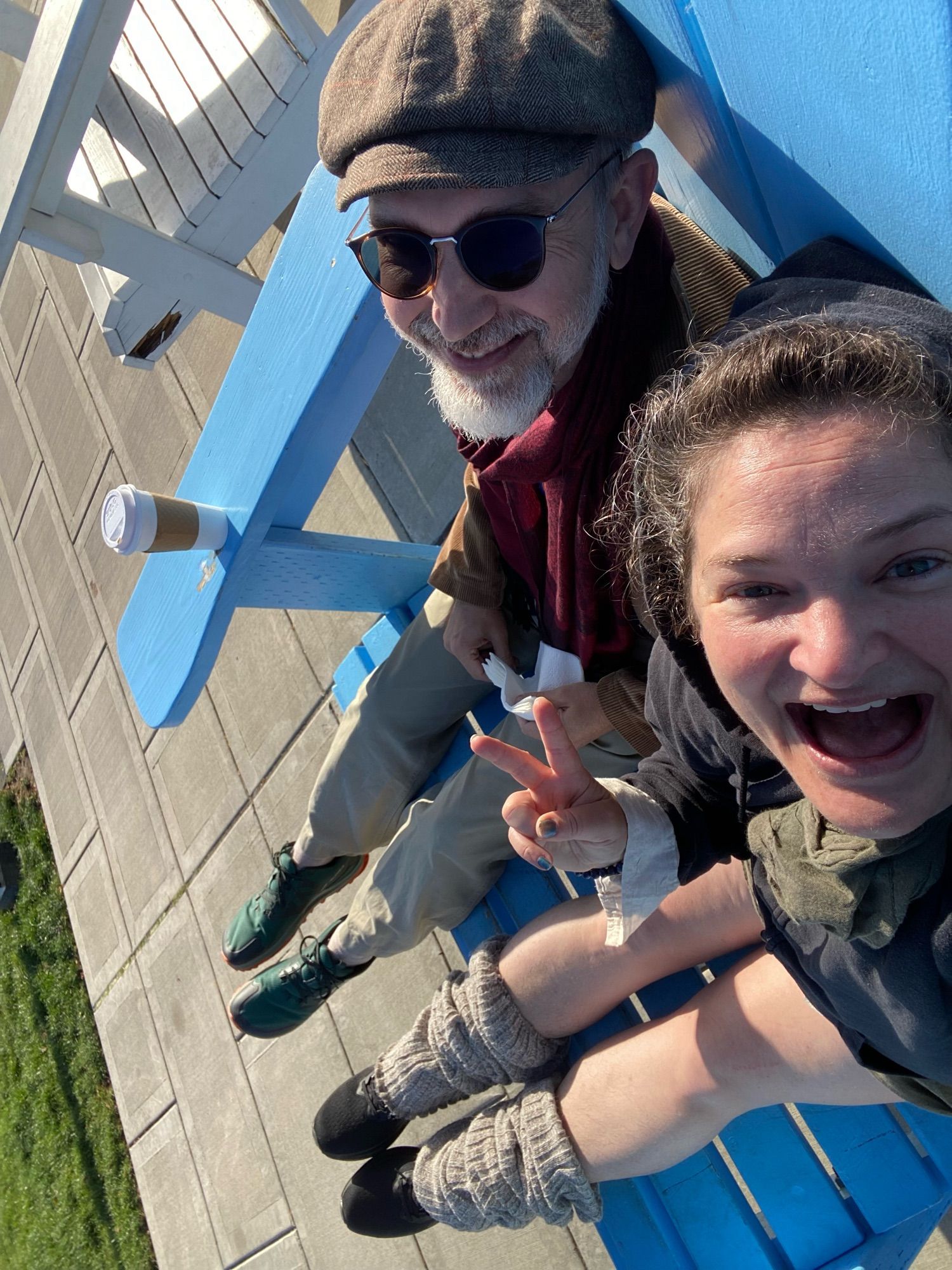 two grown-ass nerds sitting in a blue, comically oversized Adirondack-style chair, courtesy of a local chapter of the Kiwanis Club