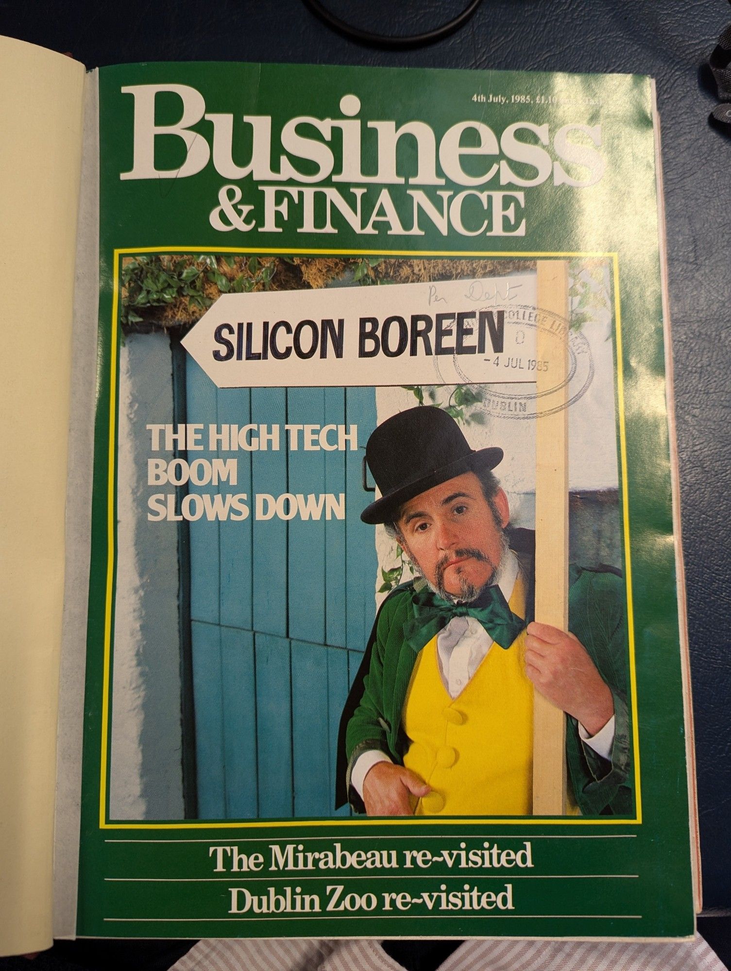 Front cover of Business and Finance magazine, 4 July 1985. The cover features the headline 'The High Tech Boom Slows Down', alongside a photograph of a man dressed in a top hat and leprechaun-like clothing. The man is holding a sign that says 'Silicon Boreen'.