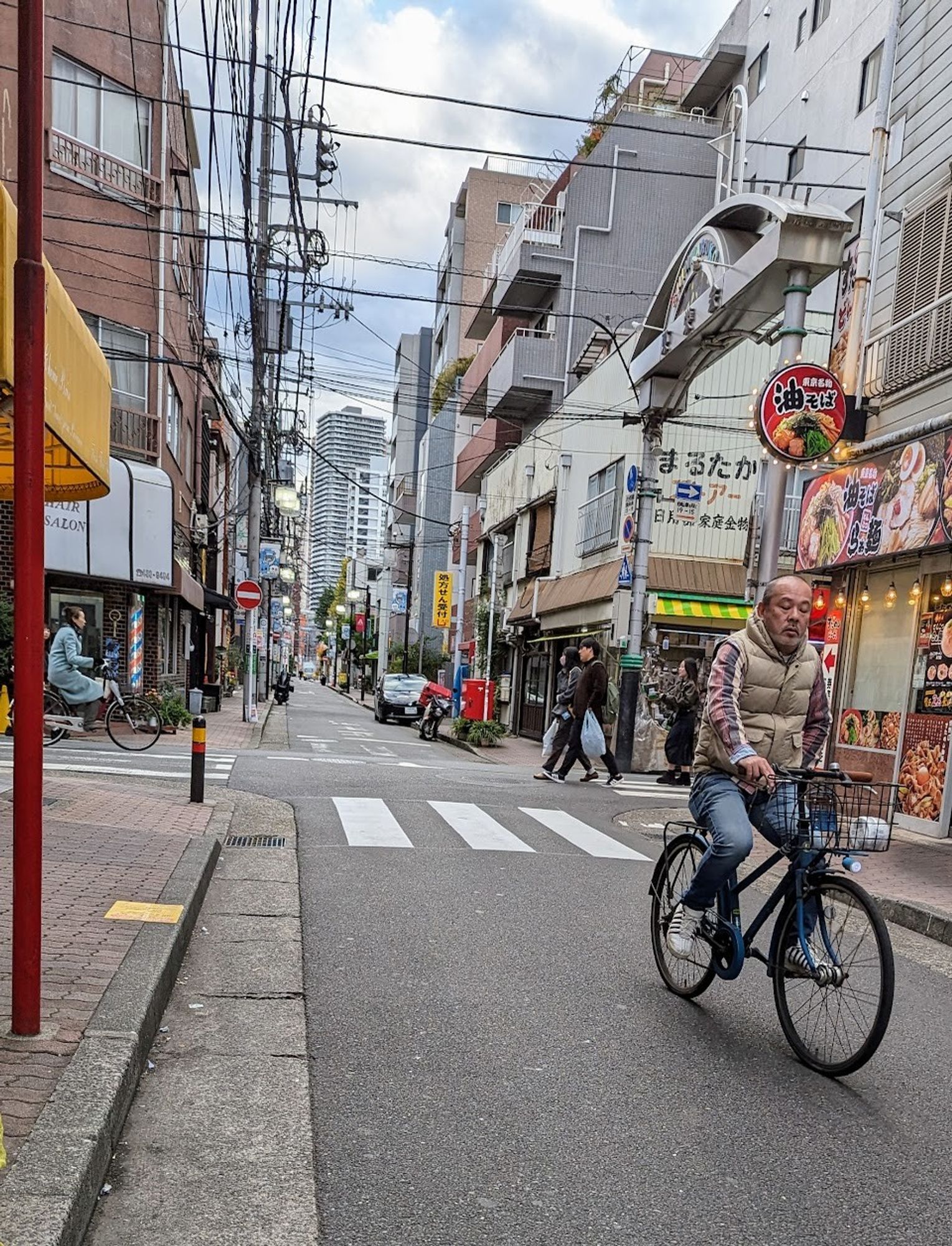 Pedestrians and cyclists on quiet streets in Japan.