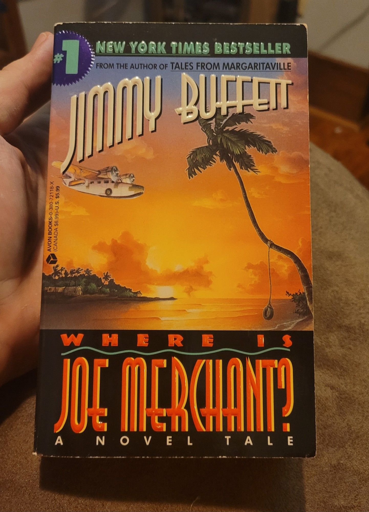 A paperback copy of the novel "Where Is Joe Merchant", written by Jimmy Buffett.