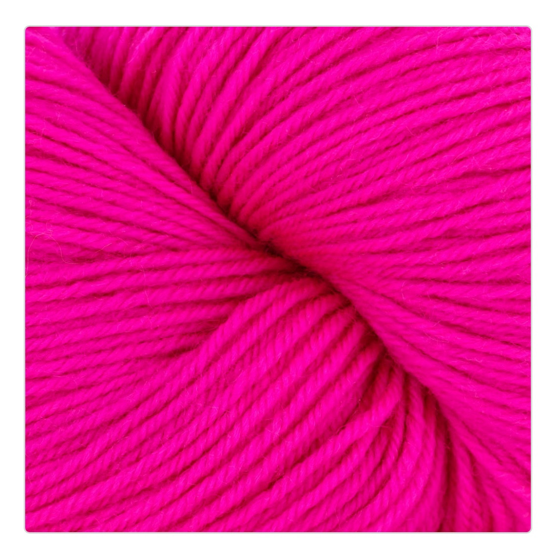 Close up image of a skein of yarn. Brand name: Cascade Yarn Heritage (sock yarn). Color: Highlighter Pink.