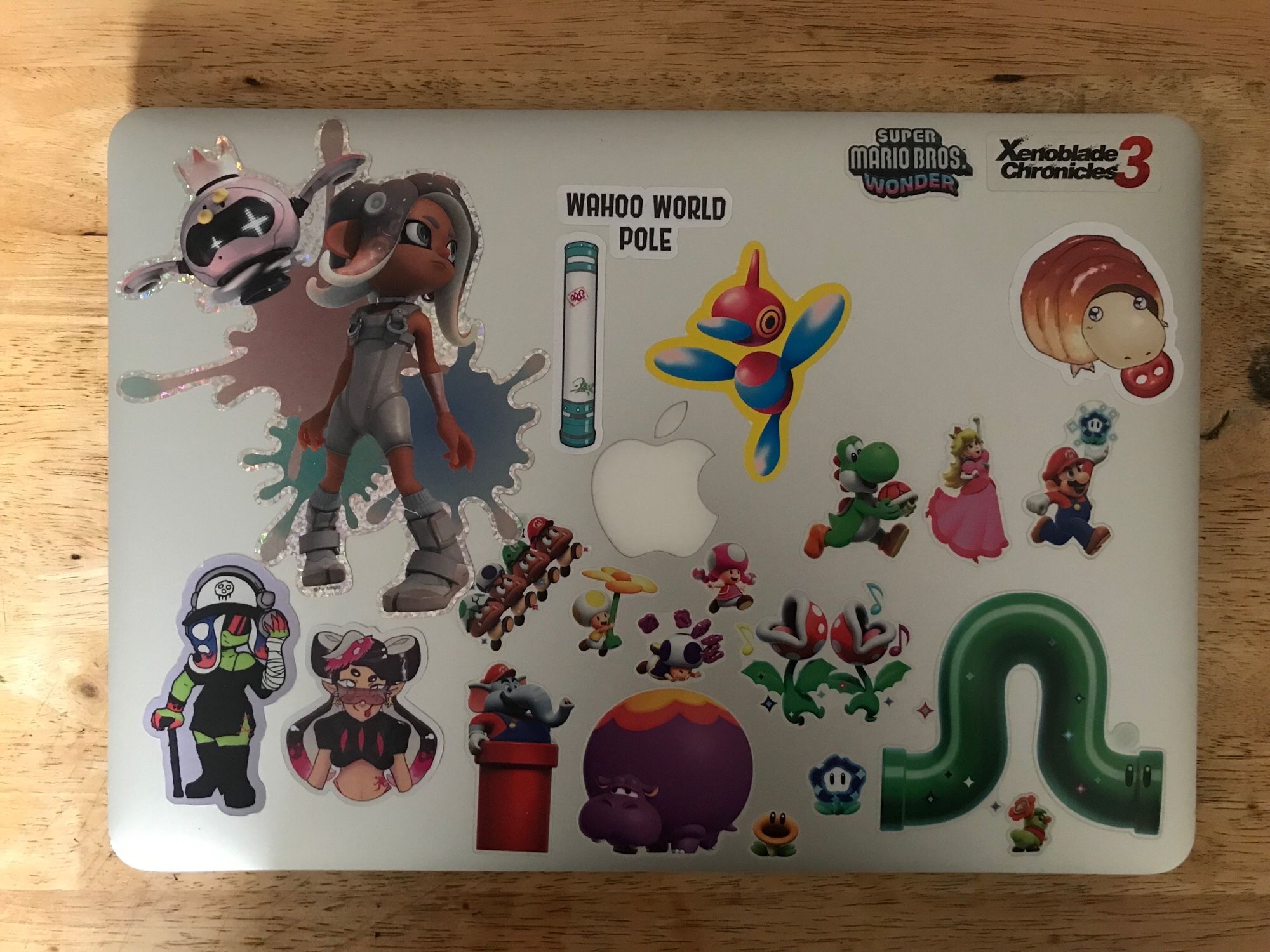 A picture of a laptop adorned with stickers, meant to show off some of the placements of the stickers.