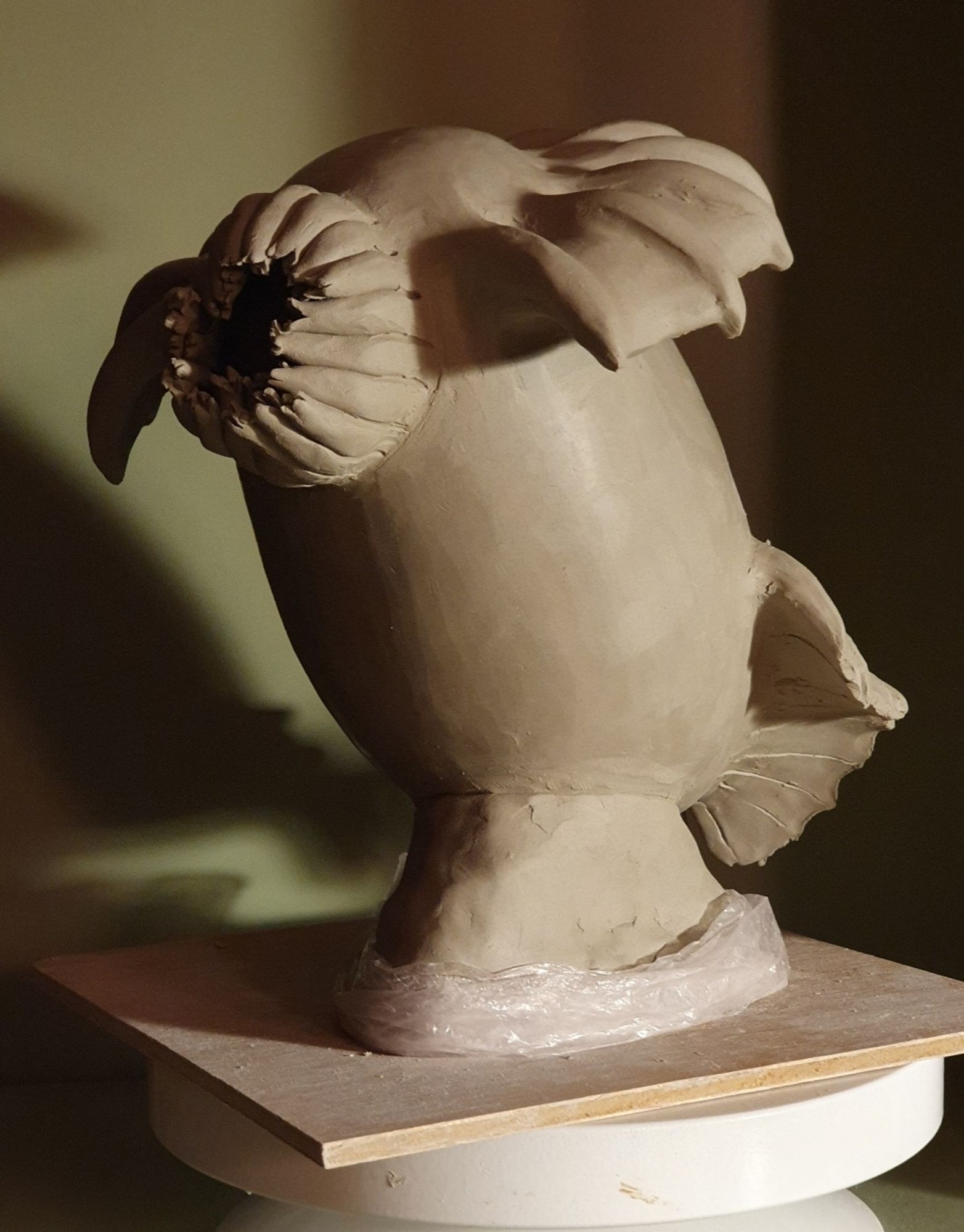 Clay sculpture of a headless chicken monster three quarter front