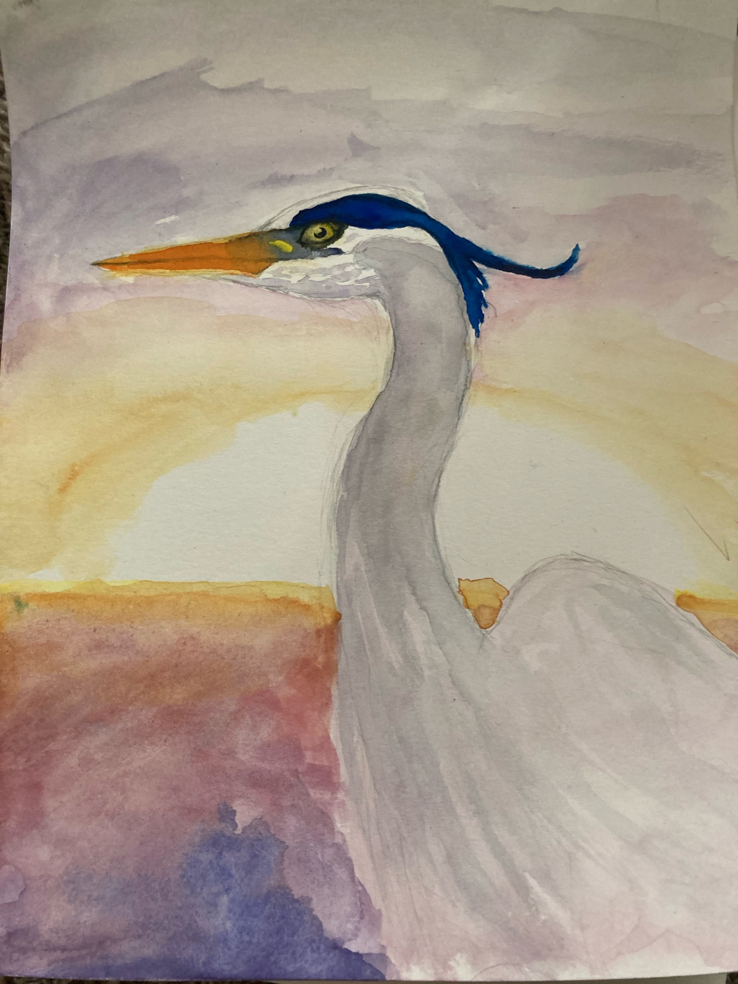 Watercolor painting of a blue heron with the sun setting over water in the background 