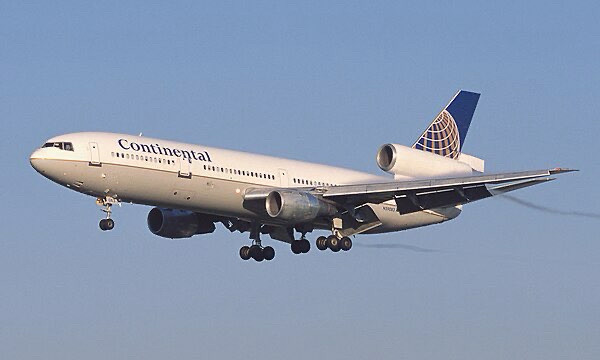 A picture of a medium size narrow body jet with three engines, one on each wing near the base, and one embedded in the tail. The plane is painted in plain Continental livery. The plane is a DC-10, not a Boeing 727