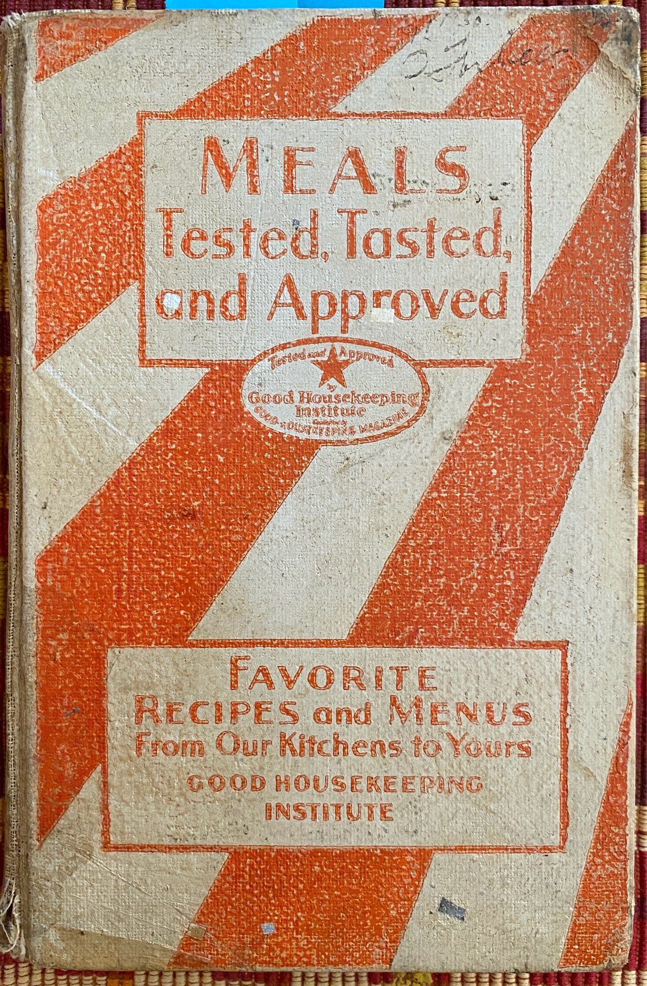 Well-worn orange & white striped book cover of Meals: Tested,Tasted and Approved by Good Housekeeping Institute 1930