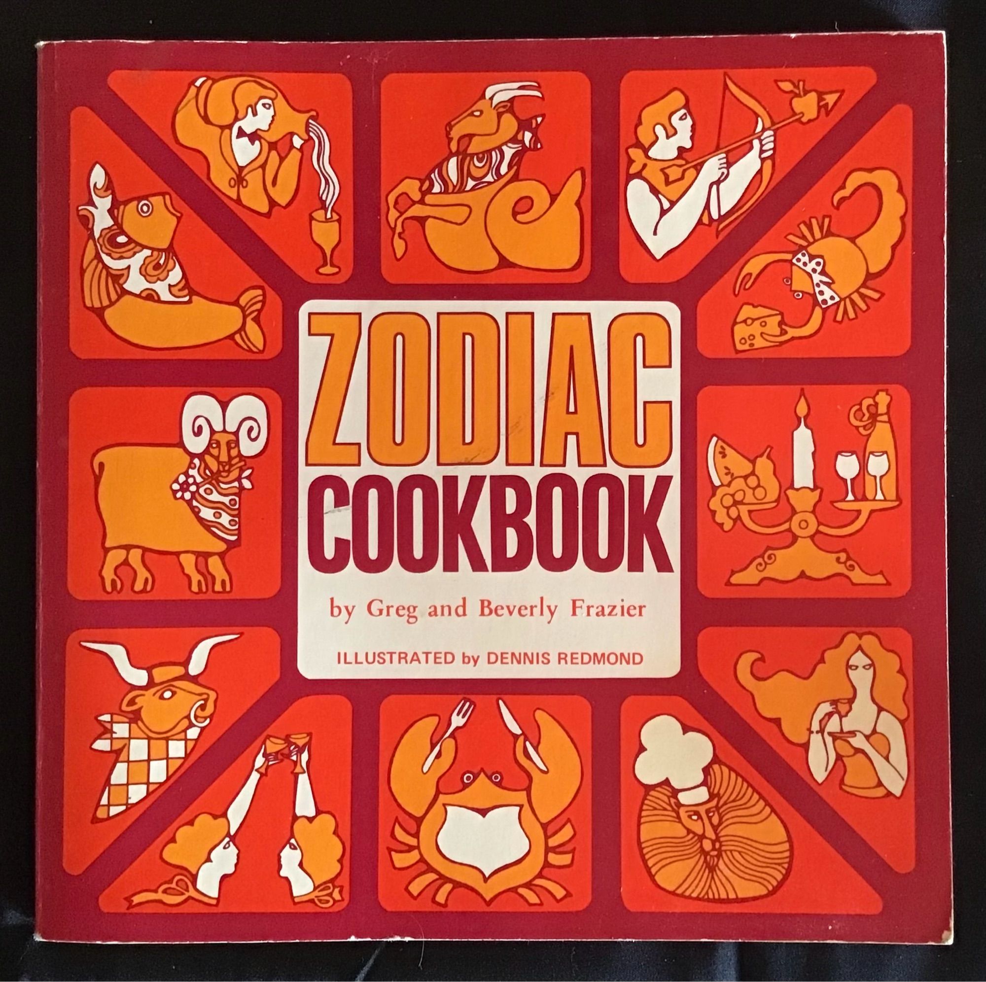 Bright orange cover of Zodiac Cookbook, with fun graphics of each sign