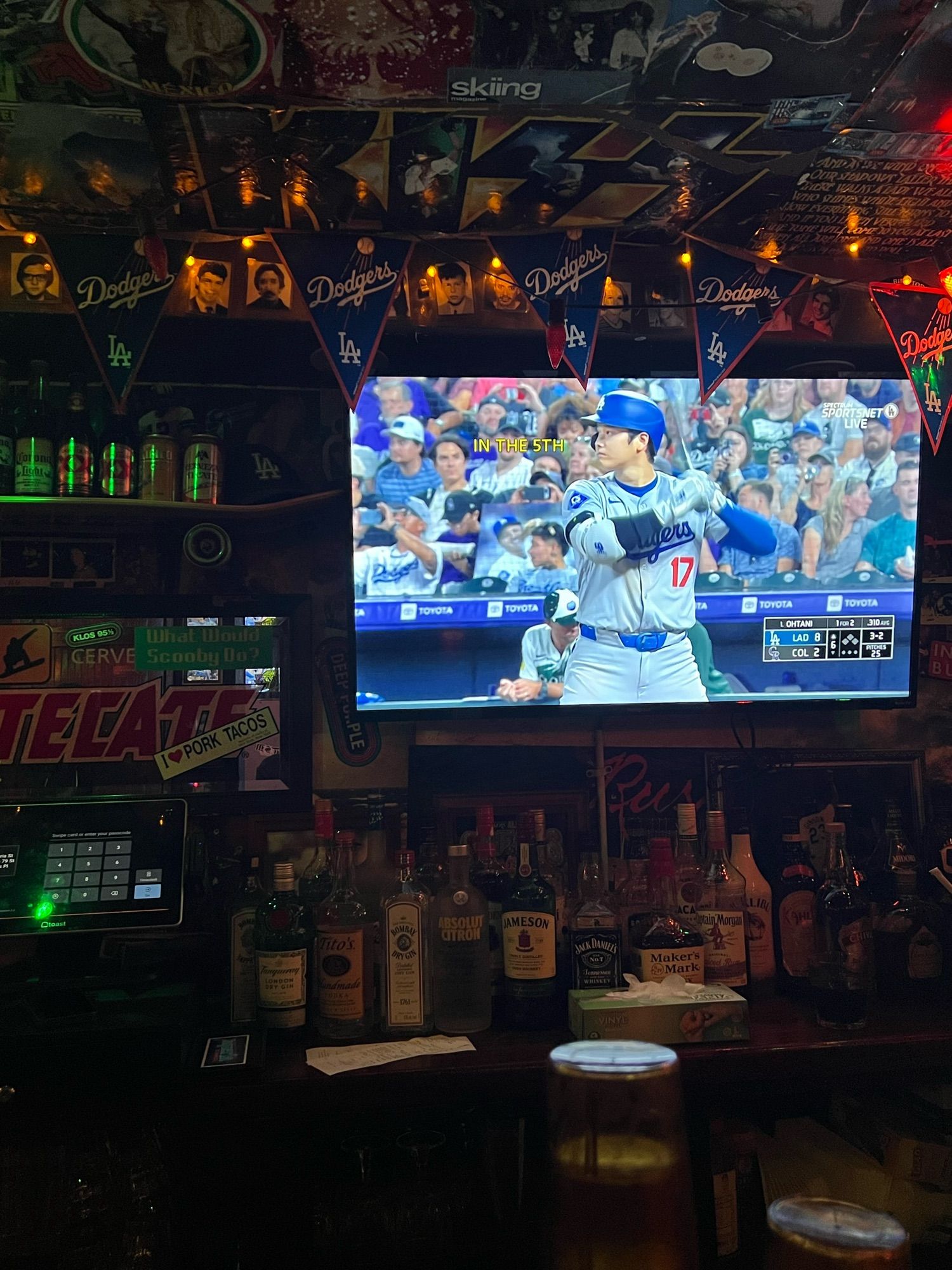 Shohei Ohtani play bat on a tv in New York taqueria.