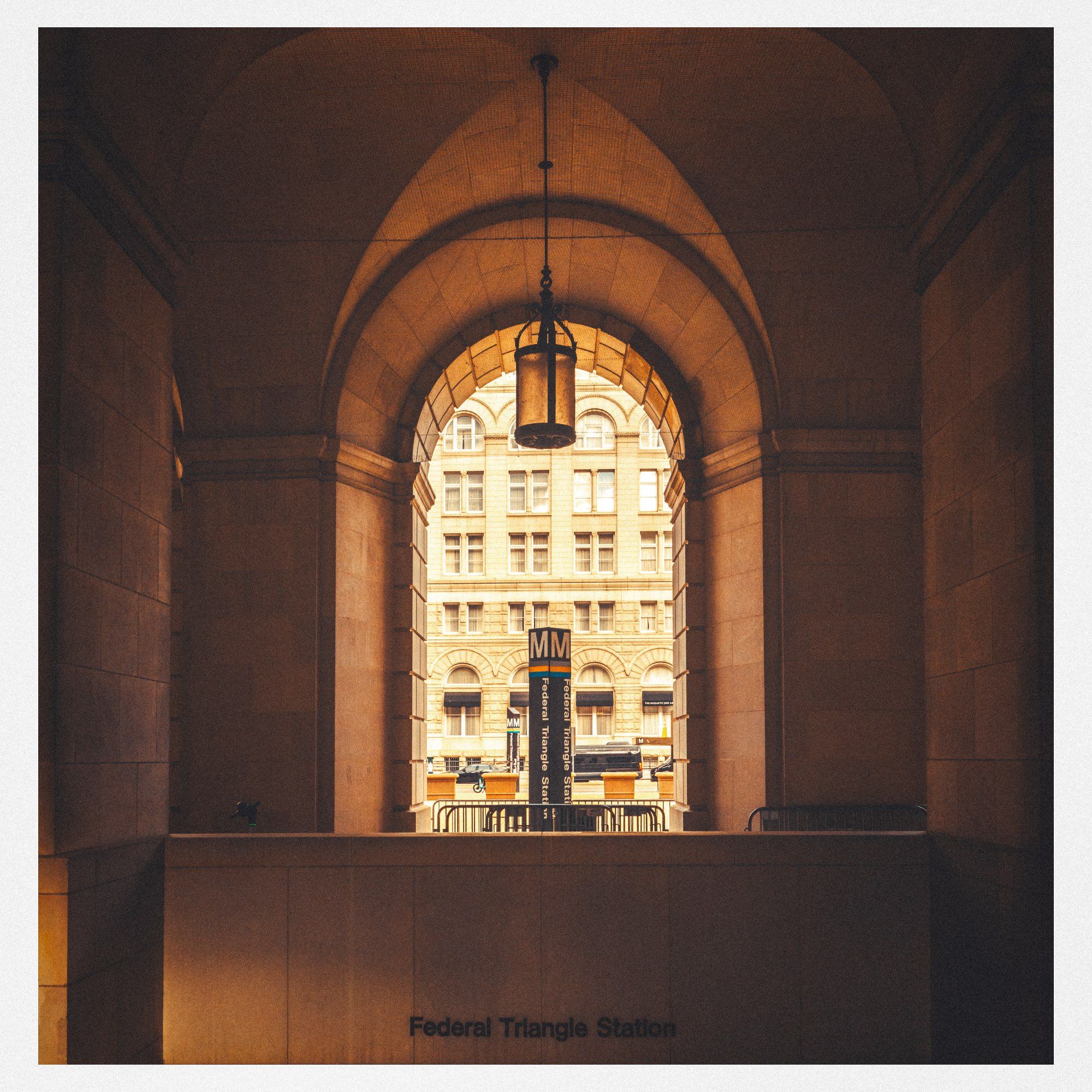 A view of a vaulted ceiling inside Federal Circle buildings & entrance to the Washington Metro wth a view outside to another marvellous old building.