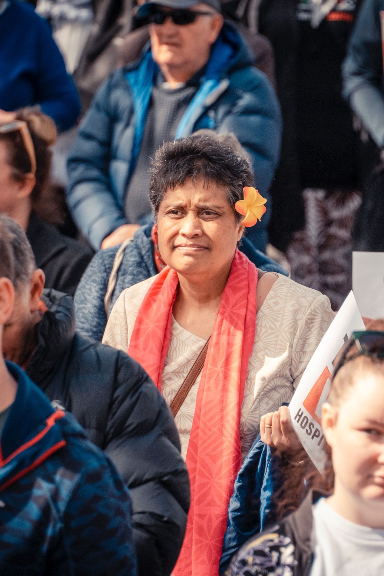 A woman wearing a lovely flower in her hair