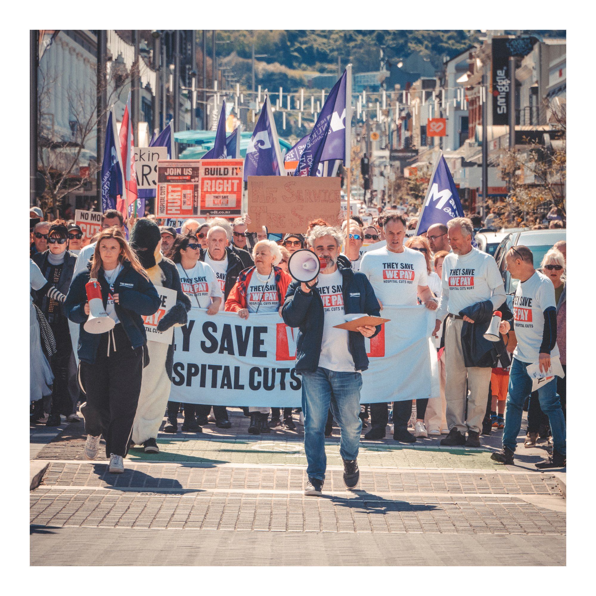 Damian And Kellie, More FM Dunedin morning radio hosts at the head of the protest, followed by Dunedin City Councillors & 35,000 holding signs & flags