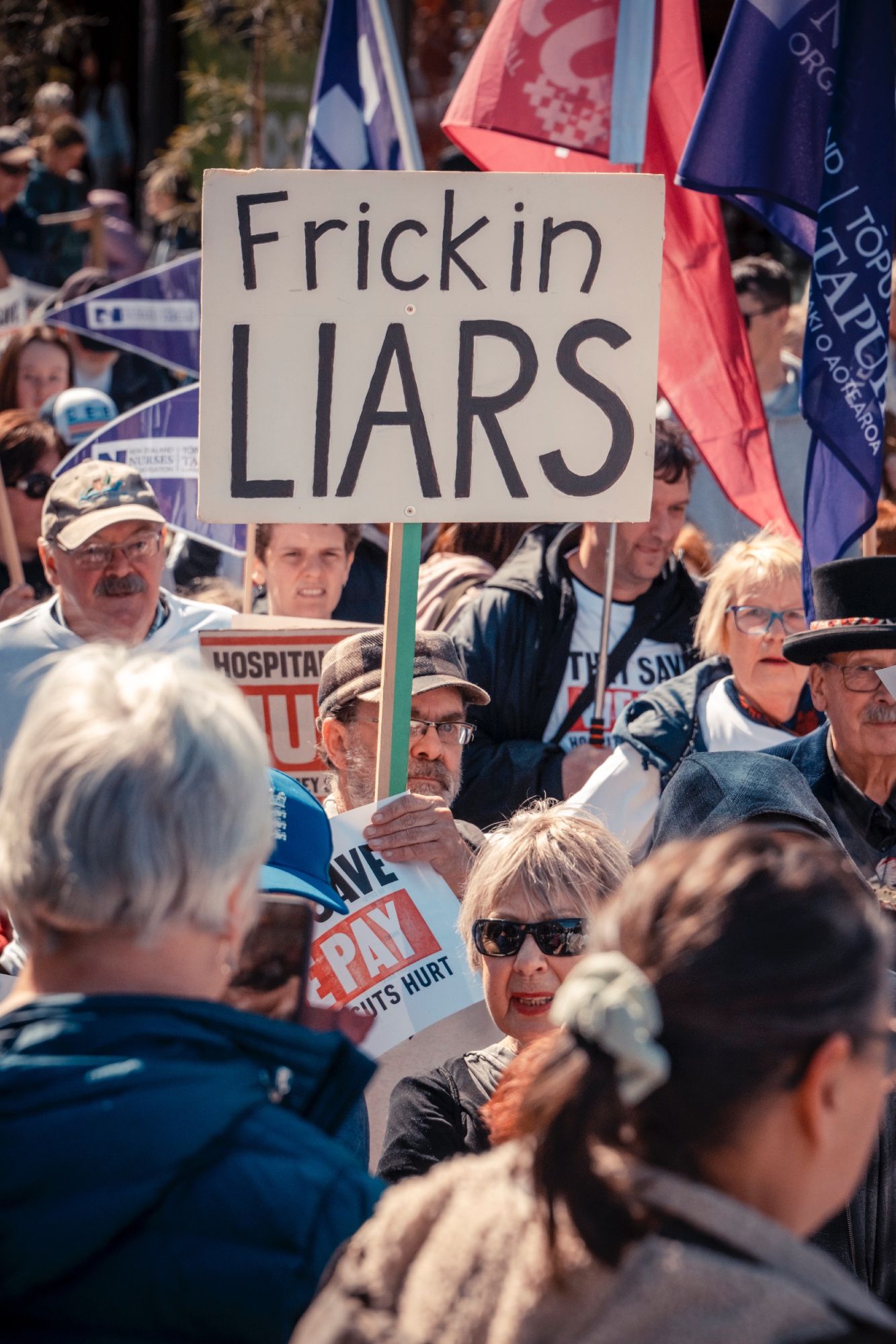 One of my all time fav musicians Robert Scott holding a sign saying 'Frickin LIARS'