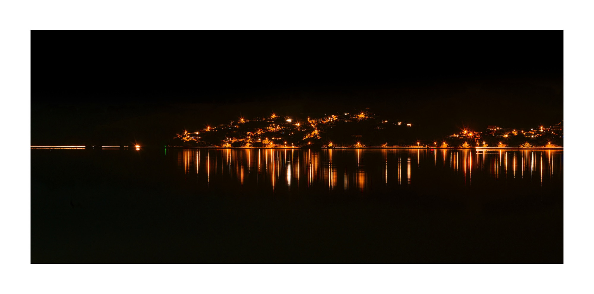 View of Company Bay with our orange hue LED street lights to help protect flora & fauna from the negative effects of the cold white light of the LED lights of the rest of the city. 

Heavy overcast night, sadly no stars. 