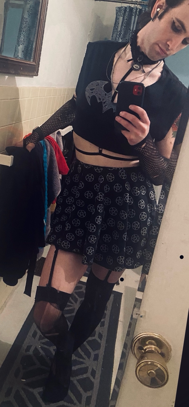 Bathroom selfie in choker necklace, pentagram skirt, harness, leggings and garter belt