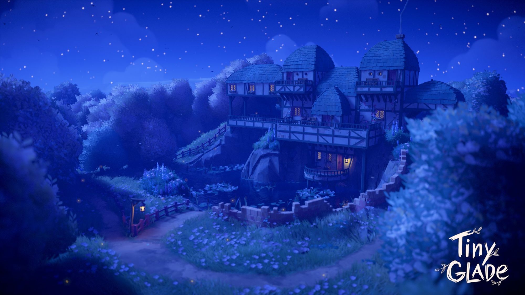 a screenshot from the game Tiny Glade of a large green and white tudor style house sitting above a large pond in a grassy meadow with pink petals and large bushy trees surrounding it. it is nighttime and there is a dark blue sky with sparkly stars behind the house.