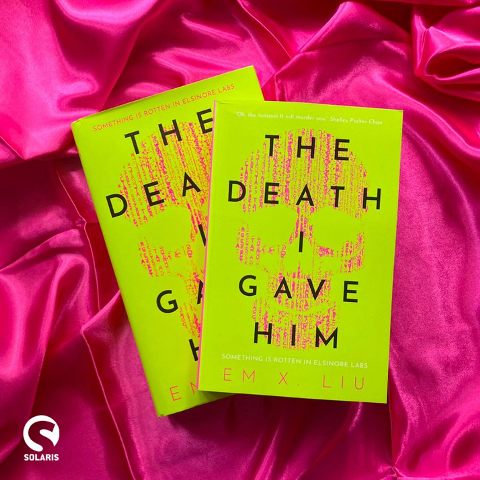 The hardback and paperback versions of THE DEATH I GAVE HIM by Em X. Liu on a pink silk background with the white Solaris logo in the bottom left corner.