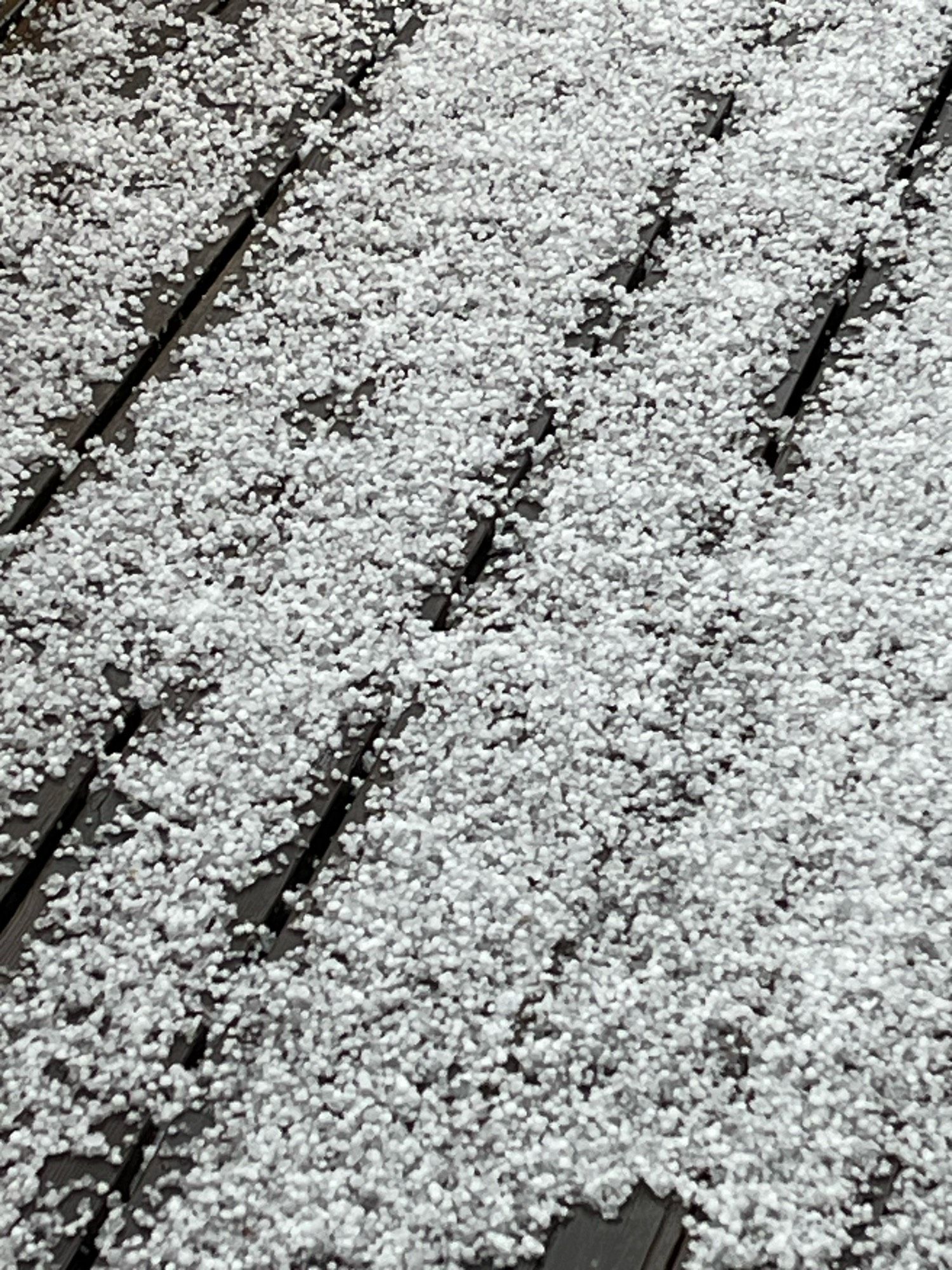 Closeup of the floor covered in hail. Pretty big ones