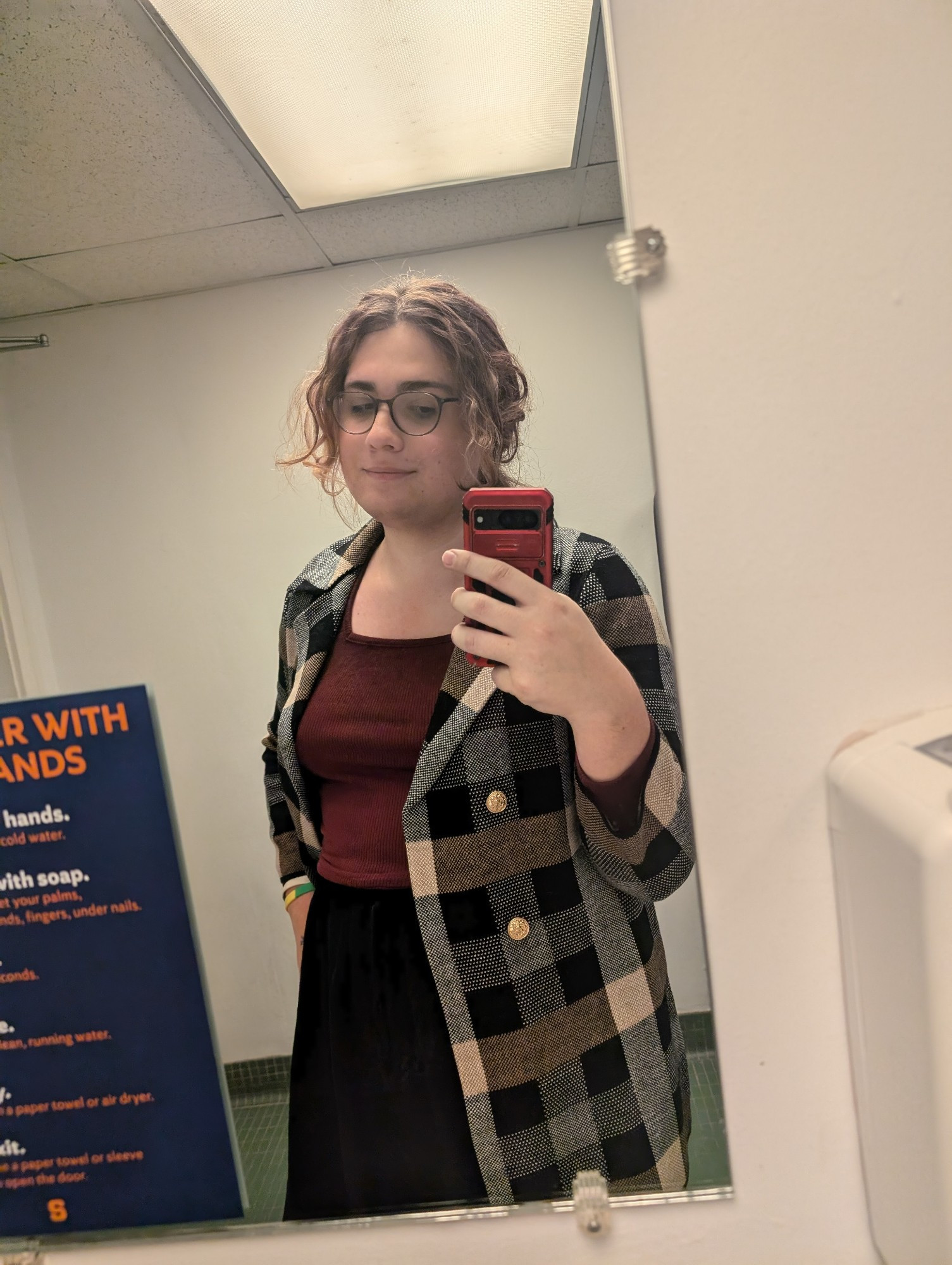 Bathroom selfie of me in a maroon top and black maxi skirt with a grey flannel blazer with off white and brown patterns and gold buttons