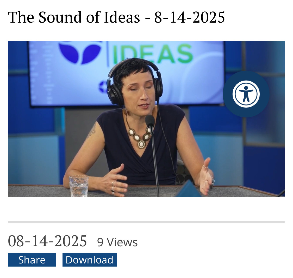 Brandy in front of a blue background talking into a microphone at sound of ideas