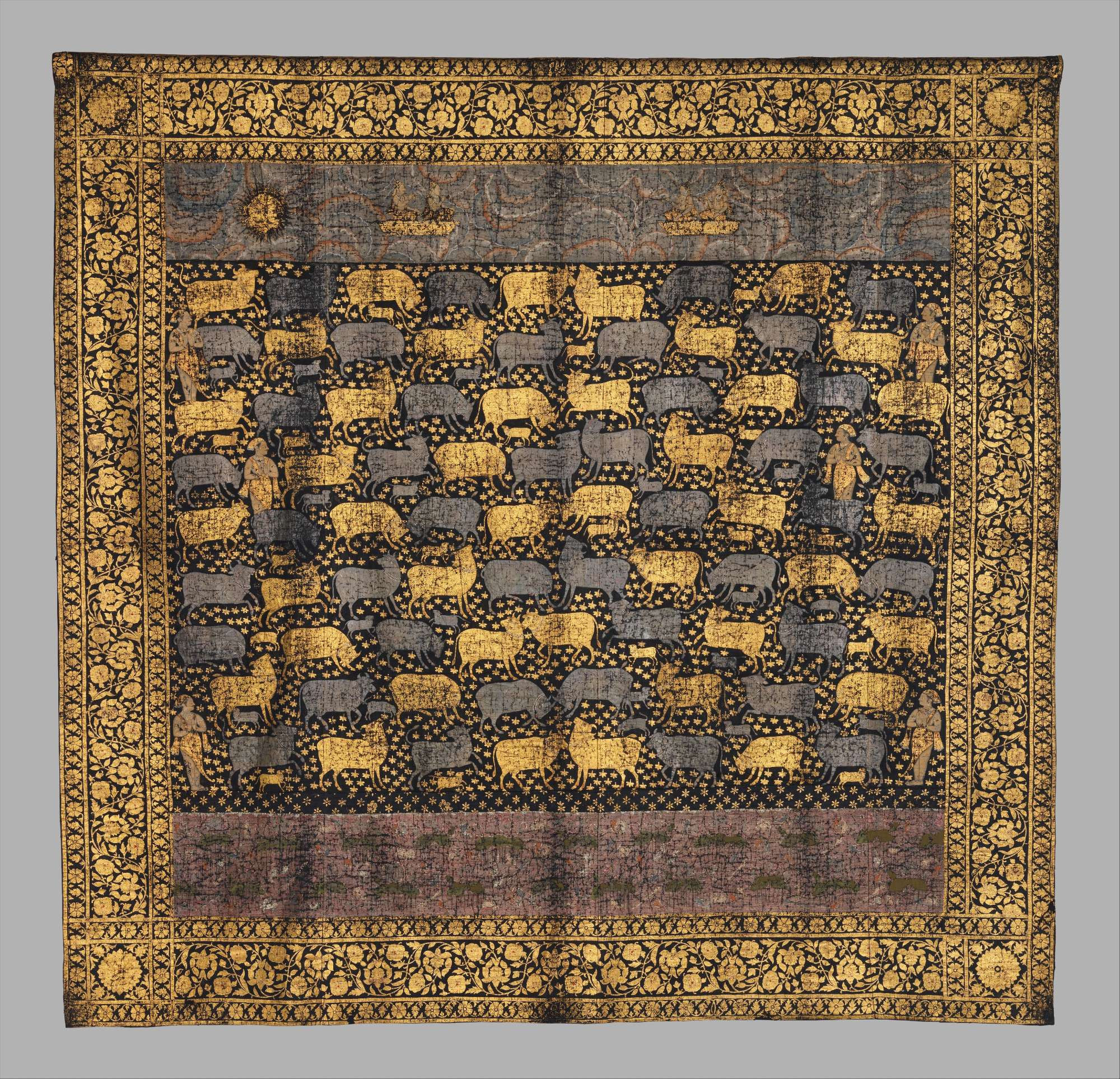 official museum photo of the pichhwai, full front view on grey background
"Large painted cloths (pichhwais) were made to hang behind the main image in a temple. This textile was produced for the Festival of Cows (Gopashtami), which occurs in the late autumn to celebrate Krishna’s elevation from a herder of calves to a cowherd. Note the range of cows and frolicking calves that populate the flower-strewn field. The indigo ground and extensive use of gold and silver are typical of pichhwais that were made for a community of Sri Nathji devotees who moved to the Deccan during this period."