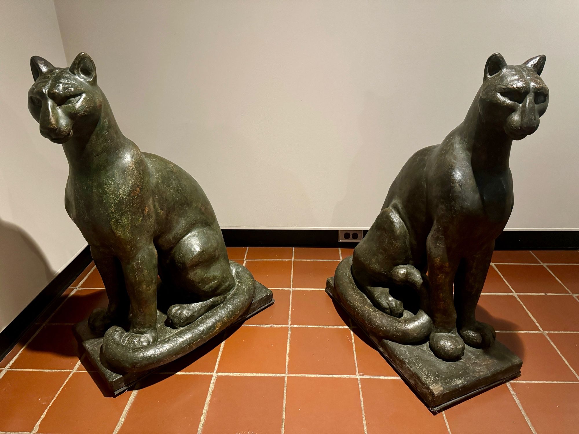 photo of the two puma sculptures on display side by side on floor in gallery