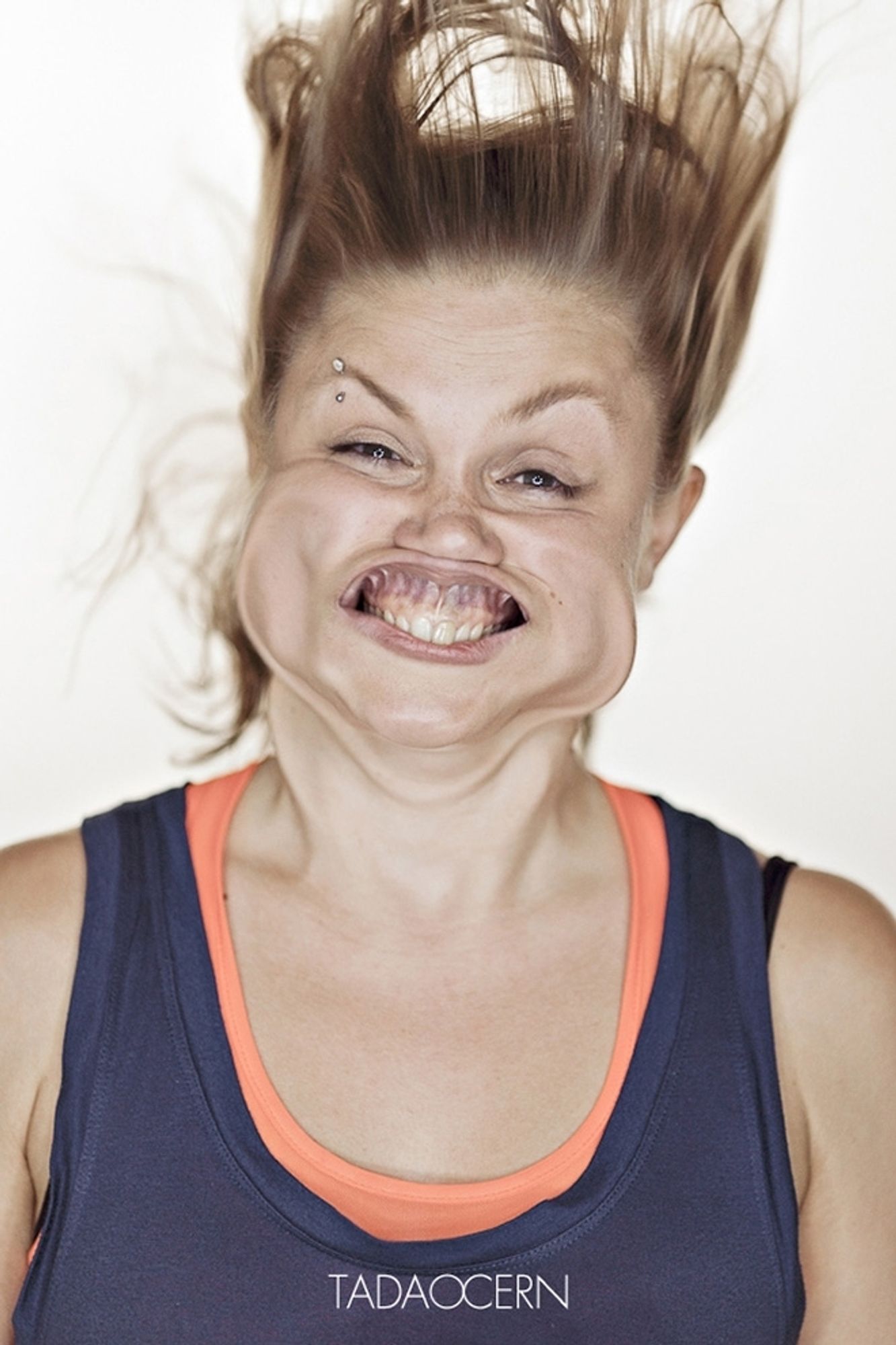 A woman in a wind tunnel with her face all wind flappy