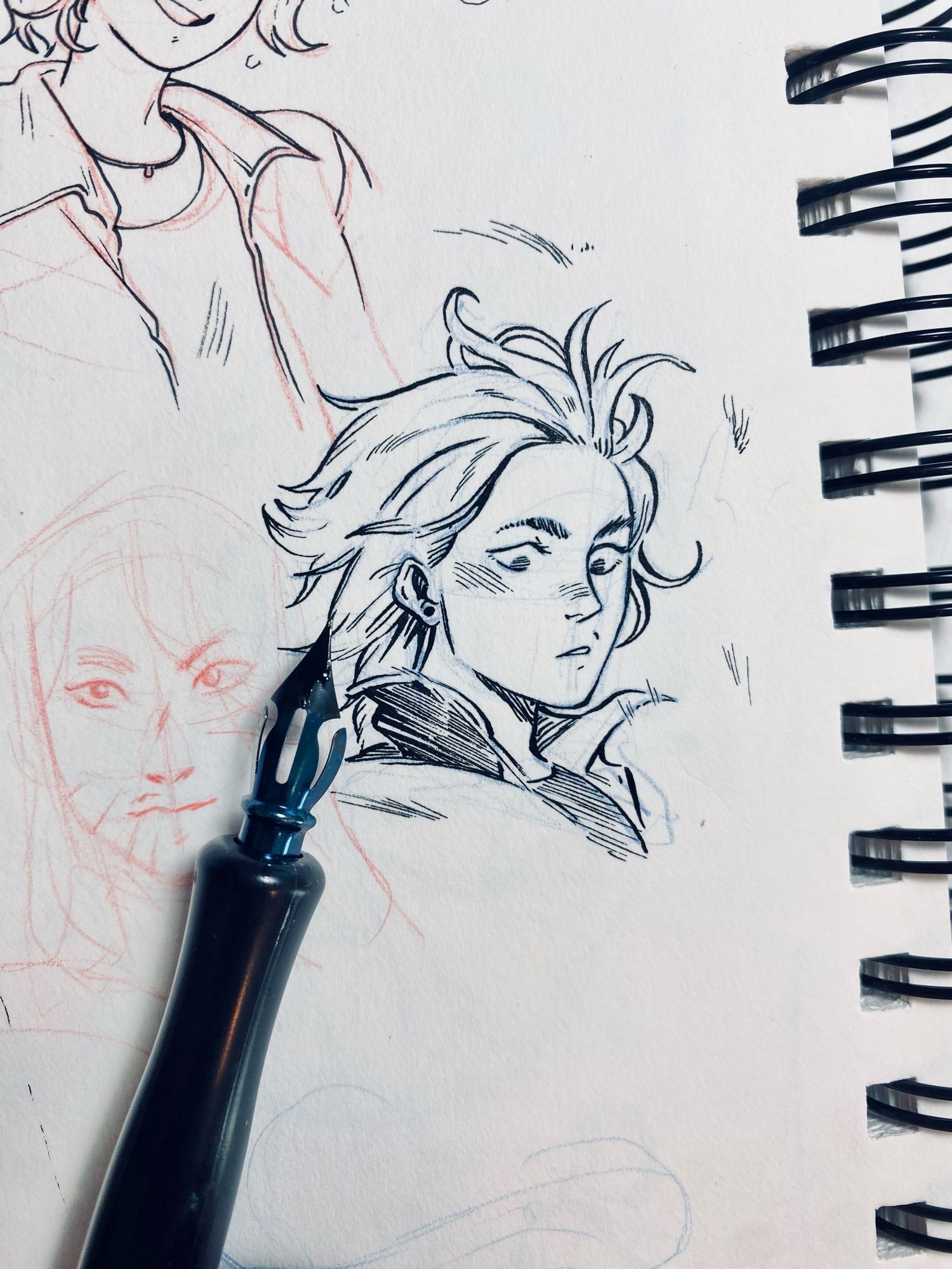 Small ink of a face. Next to it is a pumpkin nib that i used to ink it